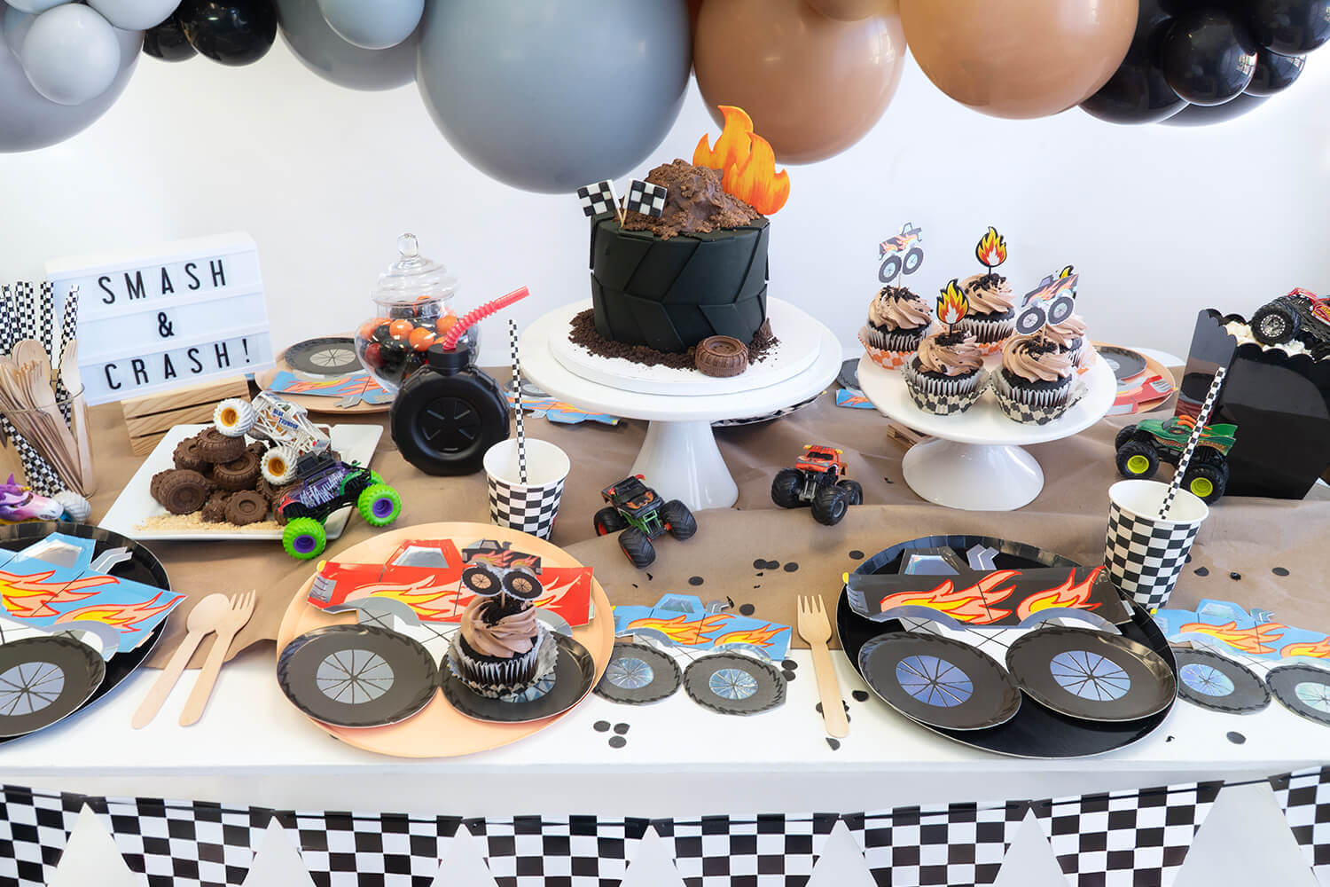 A fun kid's monster truck themed party by Momo Party featuring various monster truck themed tableware and decors.