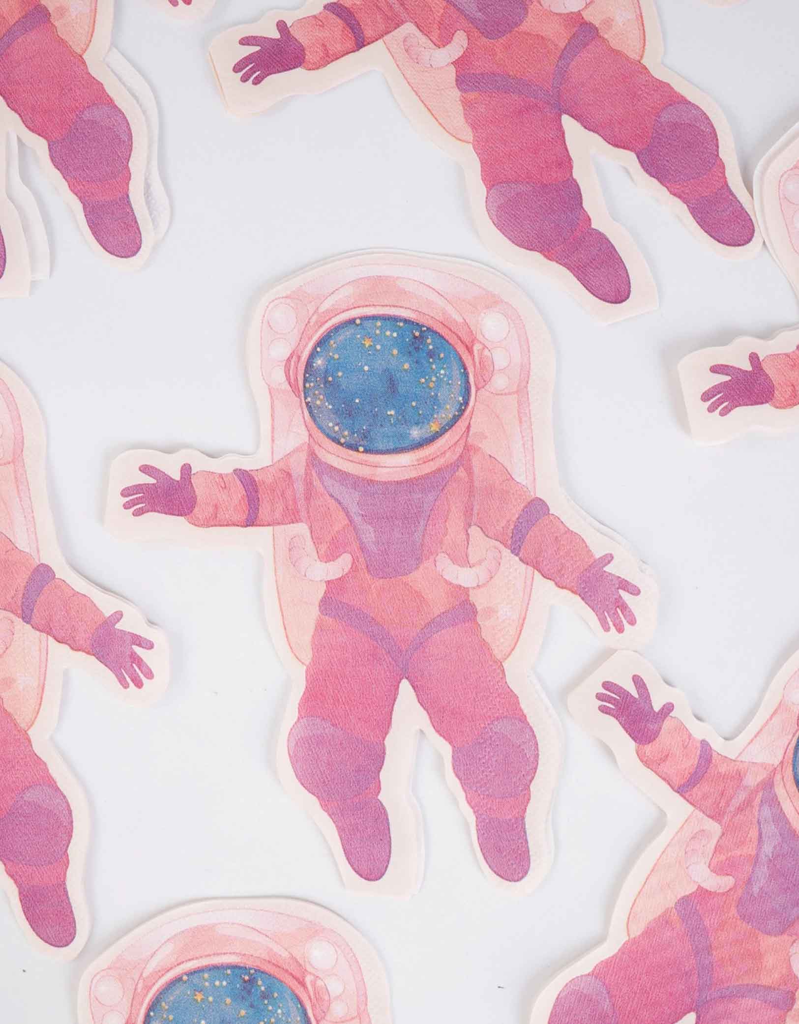 Momo Party's 7.25″ x 6.5″ pink astronaut shaped napkins spread out on a white background.