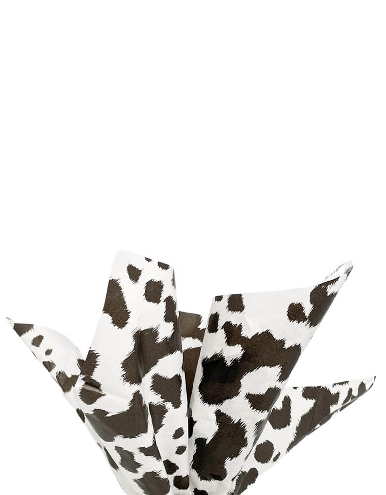 Momo Party's 19.75 x 27.5 Black Cowhide Print Tissue Paper by Party West. Comes in a set of 6 sheets, these tissue papers feature a western-inspired cowhide design and are perfect for any cowboy or cowgirl themed party. Use it for your snack basket, or party favor bags to set the scene!