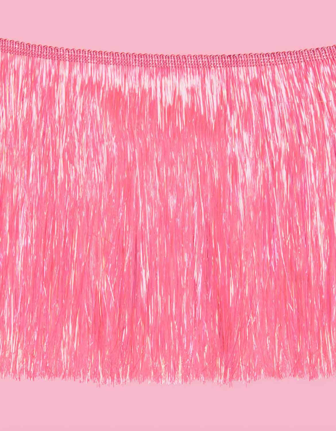 A close up shot of Momo Party's 5 ft Bright Pink Fringe Garland on a pink background.