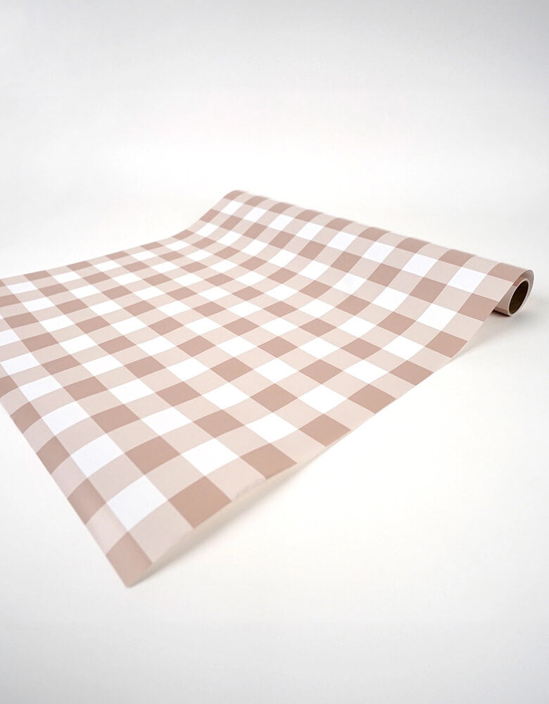 Momo Party's 18" x 120" Brown Gingham Paper Table Runner by Gatherings. Bring the merriest of moments to your holiday table with this stylishly plaid brown gingham table runner! From buffets to family dinners, this festive pattern will add a touch of classic, cozy charm that will warm up any home. Perfect for the fall holidays! Add a ravishing look to your table top with our uniquely created table runners, making your table appear more lavish. Our table runners are 100% recyclable which helps with a swift!