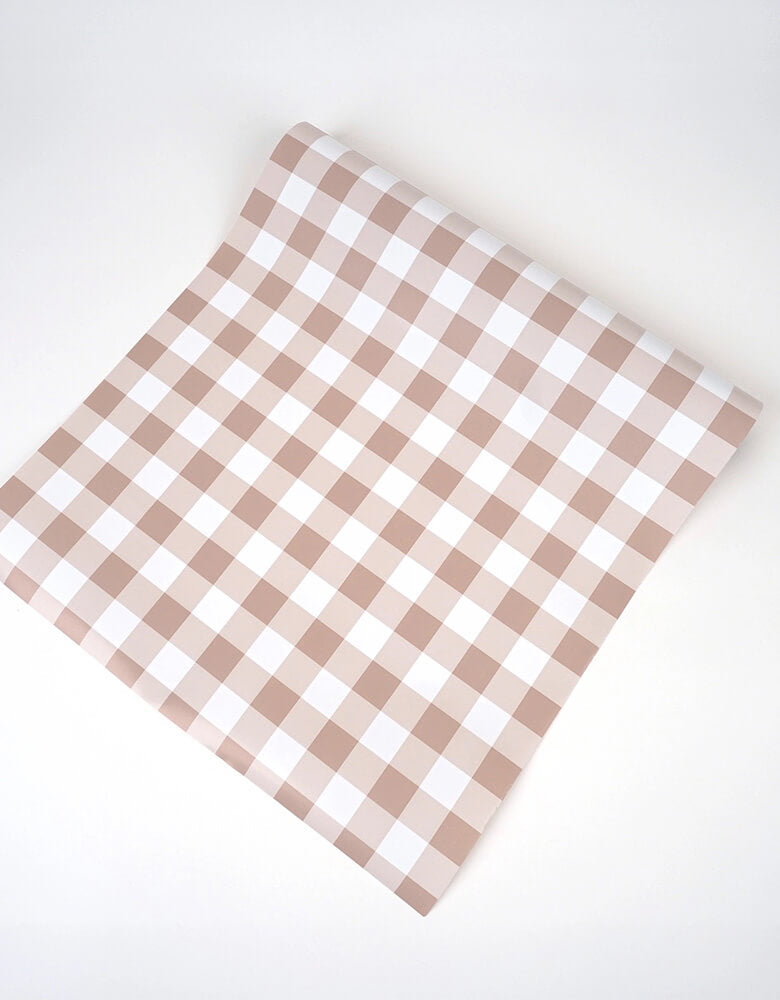 Momo Party's 18" x 120" Brown Gingham Paper Table Runner by Gatherings. Bring the merriest of moments to your holiday table with this stylishly plaid brown gingham table runner! From buffets to family dinners, this festive pattern will add a touch of classic, cozy charm that will warm up any home. Perfect for the fall holidays! Add a ravishing look to your table top with our uniquely created table runners, making your table appear more lavish. Our table runners are 100% recyclable which helps with a swift!