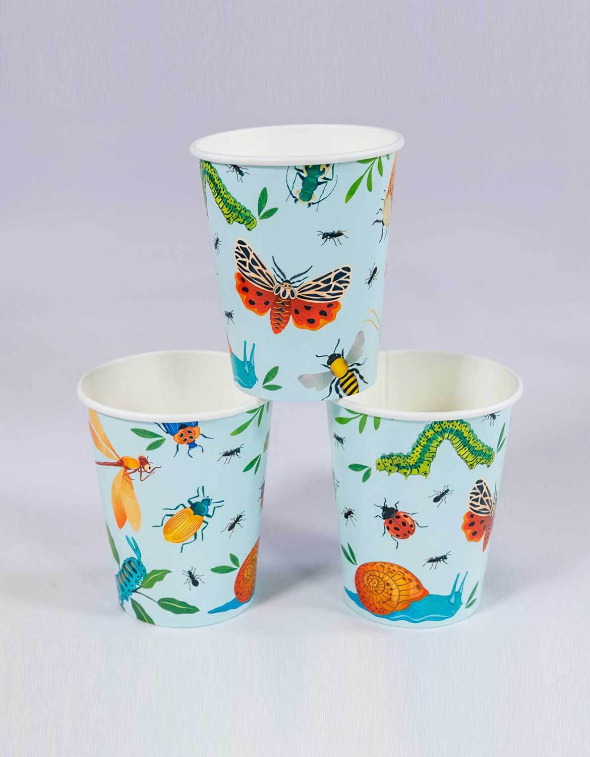 Three light blue Momo Party's 8 oz bug themed party cups with colorful insect designs from Momo Party stacked against a light gray background.