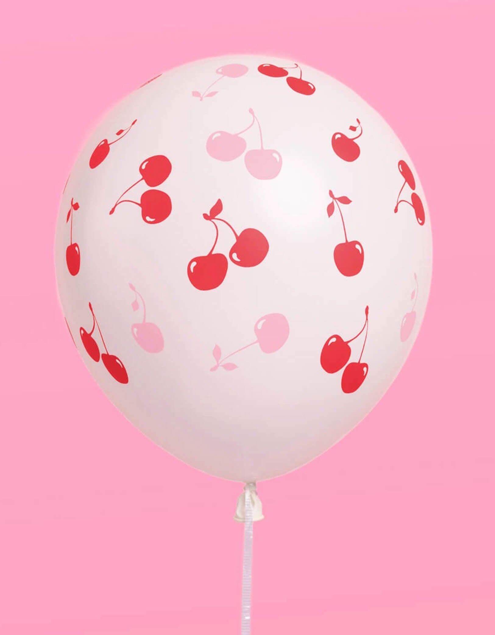Momo Party's Cherry Print Latex Balloon on a pink background.