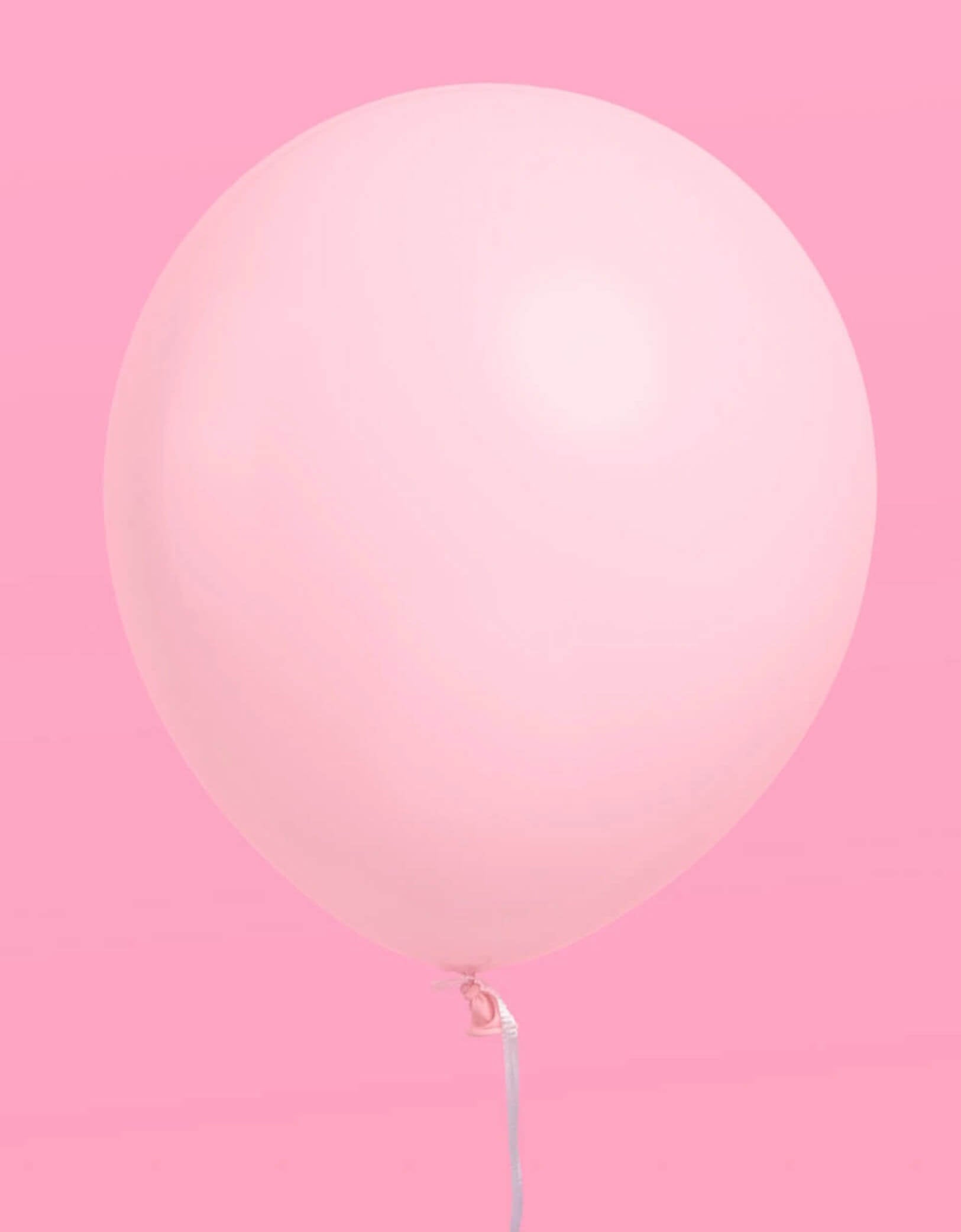 Momo Party's pink Latex Balloon on a pink background.