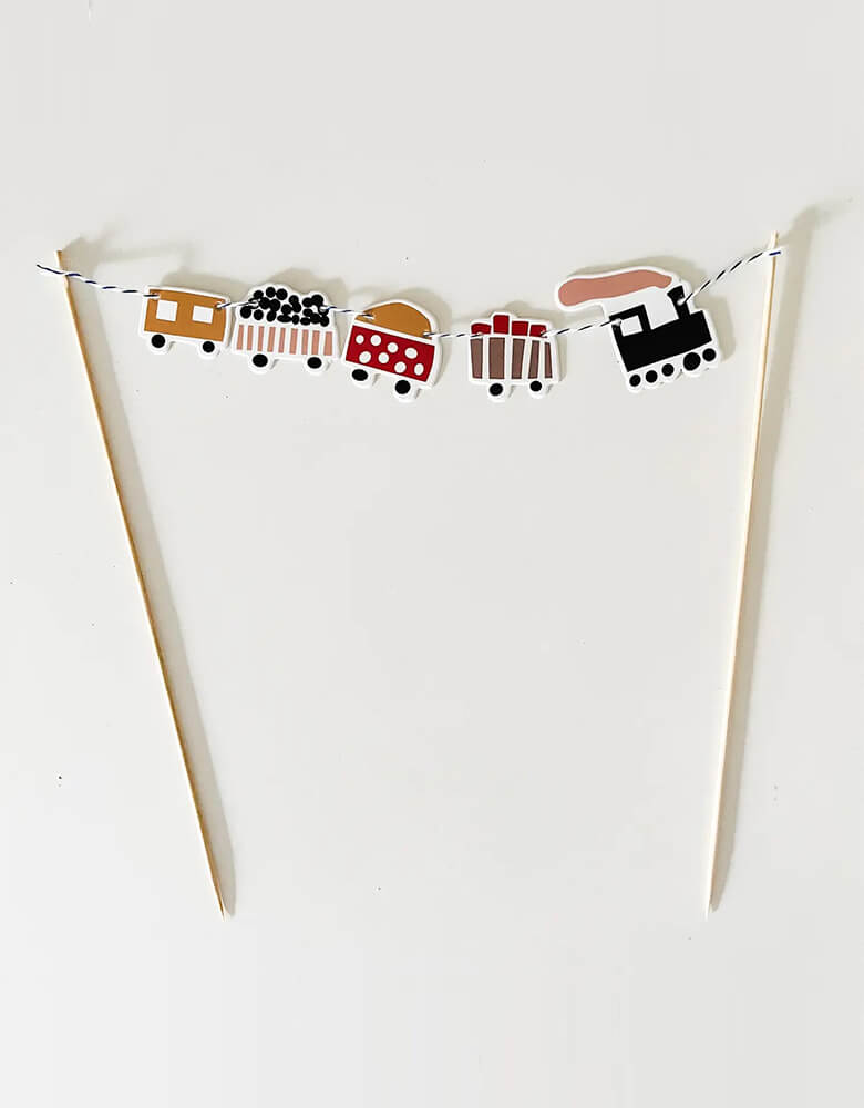 Momo Party's Train Cake Topper by Josi James. With adorable design in kid's friendly colors, this topper is a perfect addition to your kid's train themed birthday party.