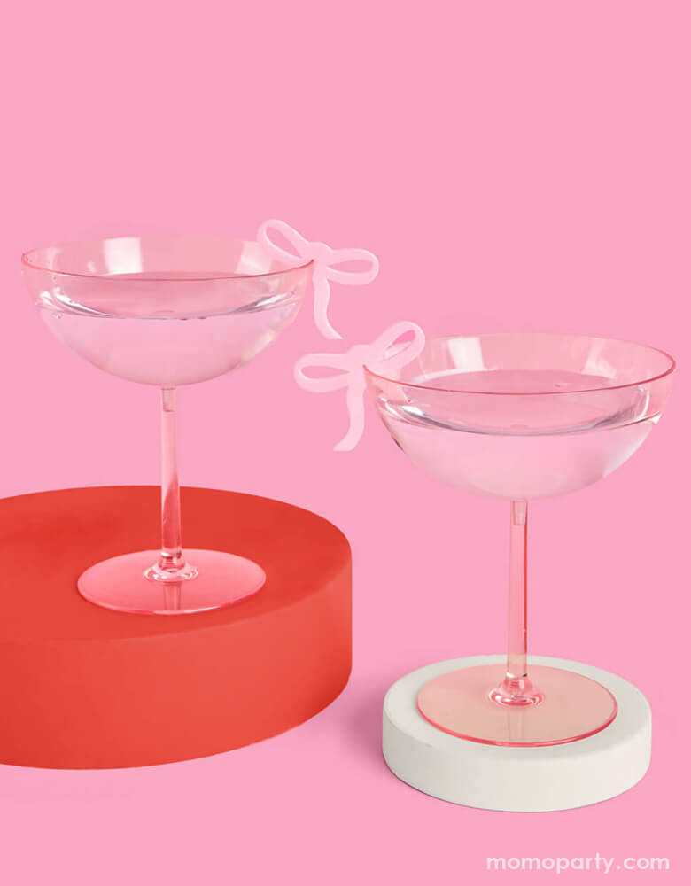 Two pink cocktail glasses adorned with Momo Party's coquette bow drink markers by Xo, Fetti on a modern drink display. Whether it's a bday, bridal shower, or a bachelorette party, celebrate in bow bliss with these super cute drink markers.