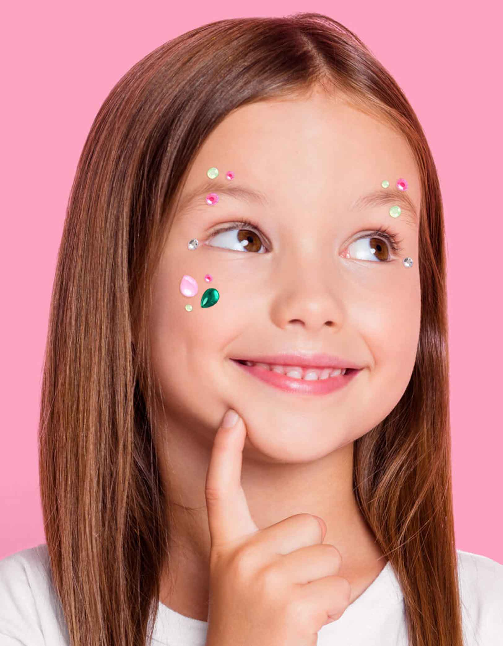 A young girl with Momo Party's Wicked themed gem stickers on her face against a pink background. Perfect for girl's Wicked themed birthday party, witch themed Halloween bash or a magical gathering.