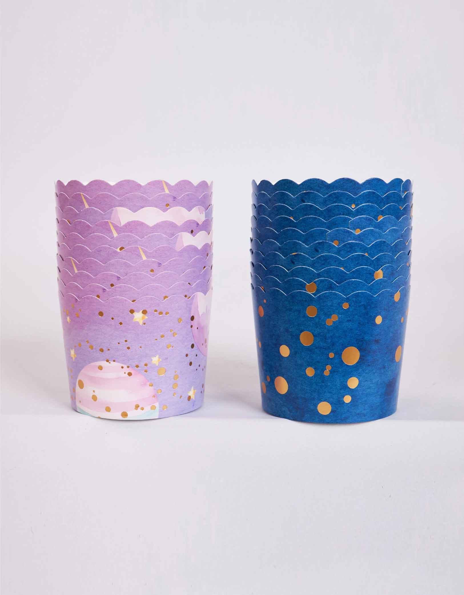Two stacks of Momo Party's space themed food cups with decorative patterns in pastel lilac and galaxy blue on a white background.