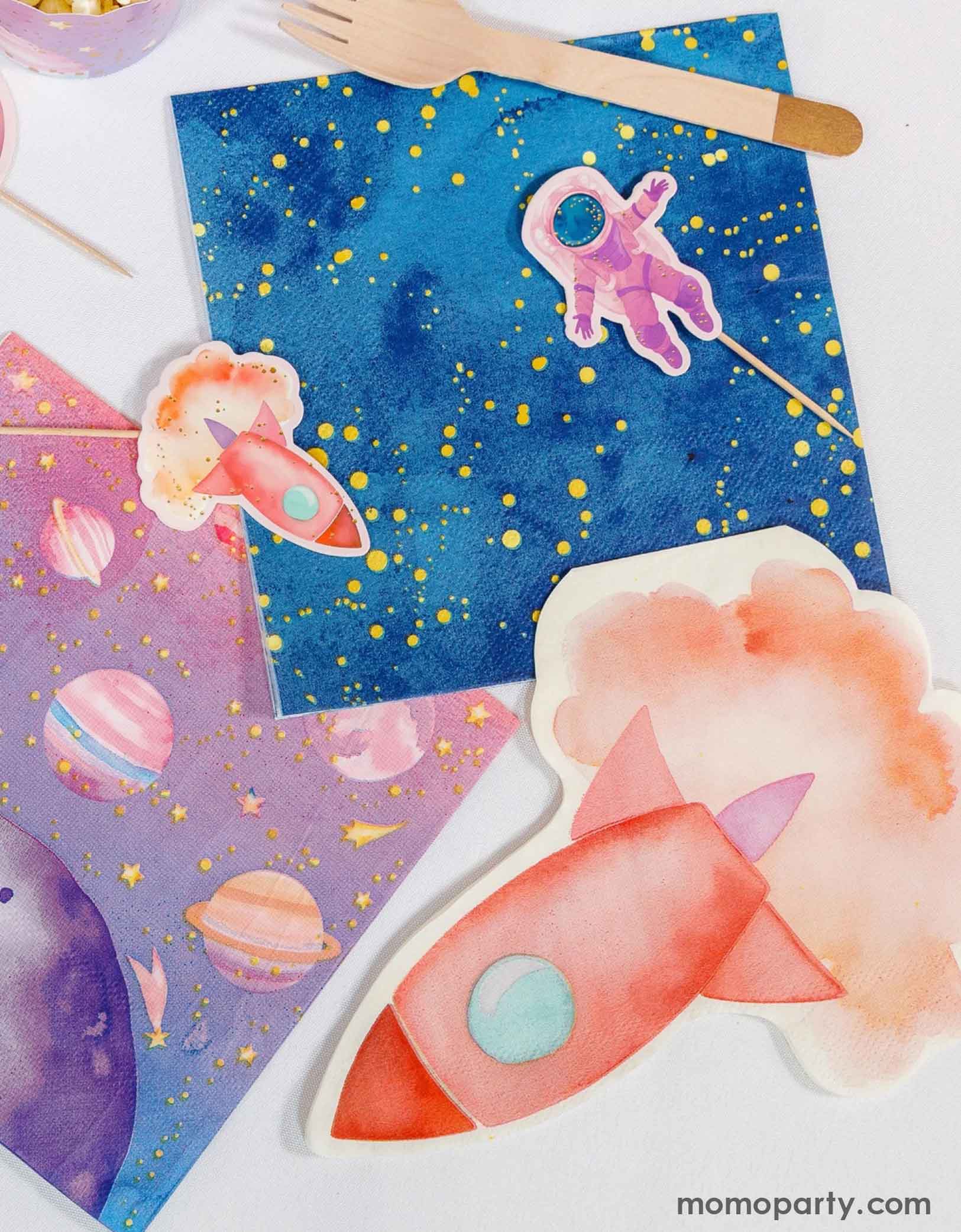Momo Party's girly colorful space-themed party tableware and decorations including paper toppers of a rocket, an astronauts, pink space themed party napkins and a pink rocket ship shaped napkin on a white background.