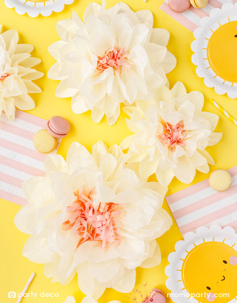 A cheerful table decoration features Momo Party's sunflower sunny scallop edged round plates, pink and white striped large napkins and cream tissue paper flower decorations, with some macarons and sweet desserts, this makes a great idea for kid's "You're my sunshine" themed party or any "Good Vibes" themed celebration!