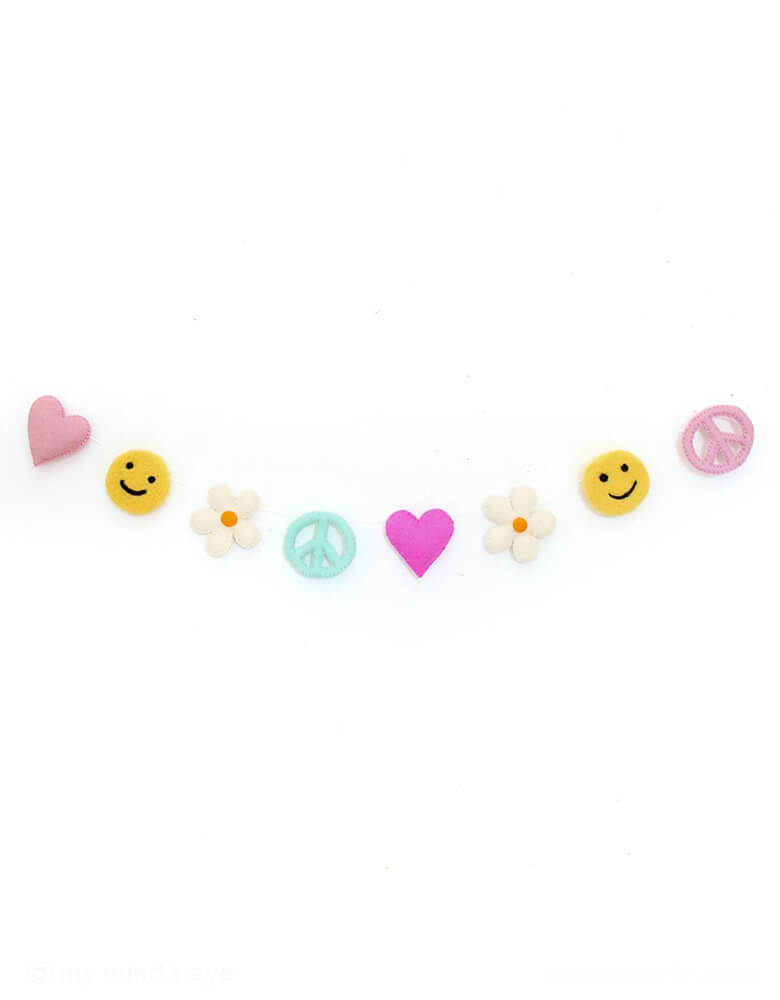 Momo Party's Groovy Love felt garland by Kailo Chic. Featuring peace signs, daisies, hearts, and smiley faces, this funky garland is perfect for adding a playful touch to any space. Perfect for a retro themed birthday party, be it a "Groovy One" first birthday or "Two Groovy" second birthday party for toddler girls.