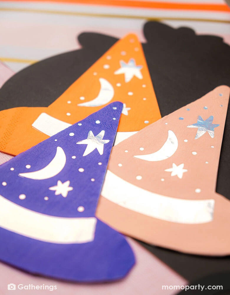 A close-up shot of Momo Party's 5.5" Bewitching Hat Shaped Napkins by Gatherings. Featuring intricately designed witch hats, these napkins will charm your guests and elevate your Halloween celebrations. Get ready to brew up some fun and create a bewitching atmosphere with these napkins.