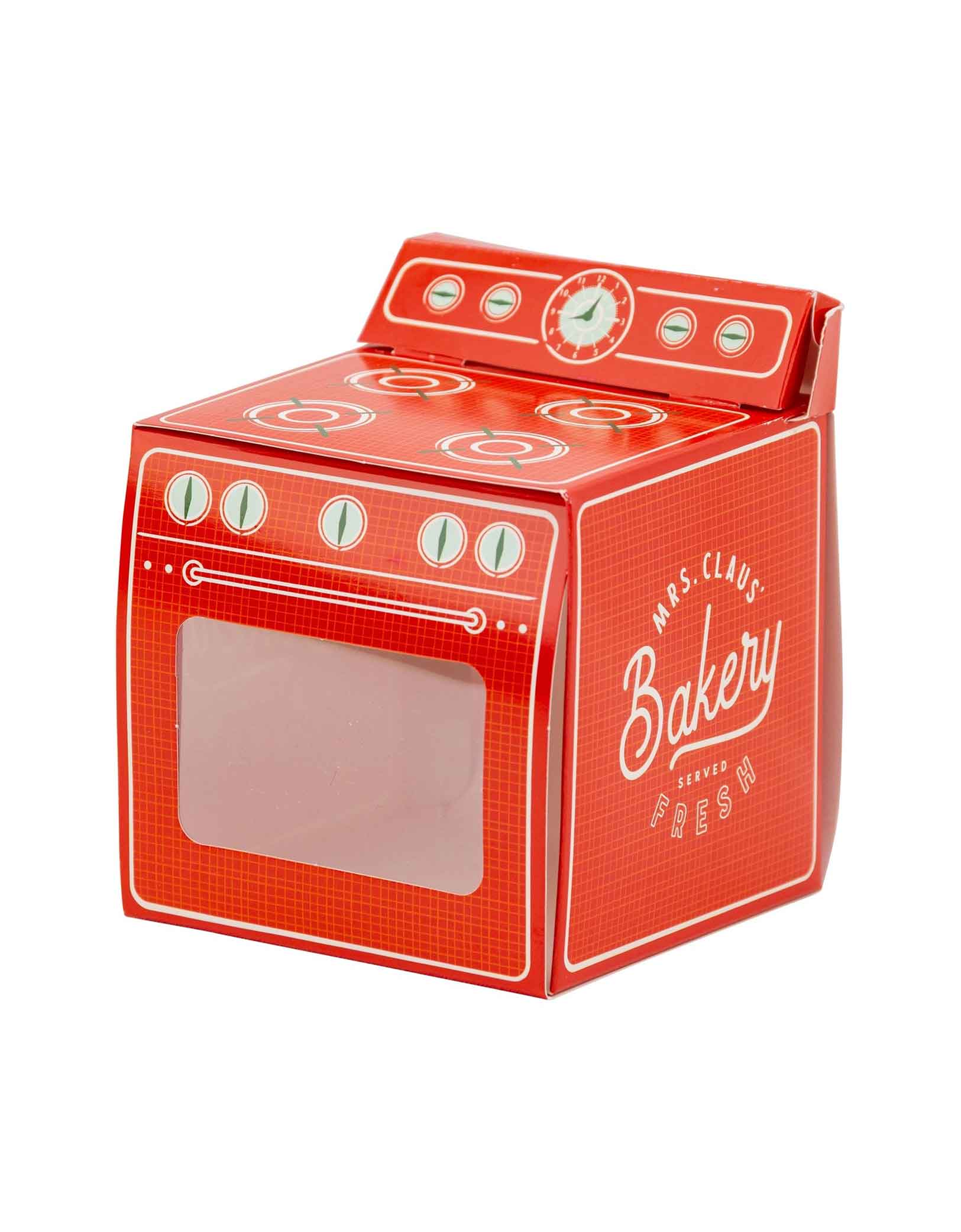 Momo Party's 3.5" x 4" x 3.5" Oven Shaped Treat Box with 'Mrs. Claus' Bakery' branding on a white background. This box adds a cheerful touch to any party spread. Perfect to hold a cupcake! Ideal for gifting or serving, it makes sharing homemade oven-baked delights easy and stylish.
