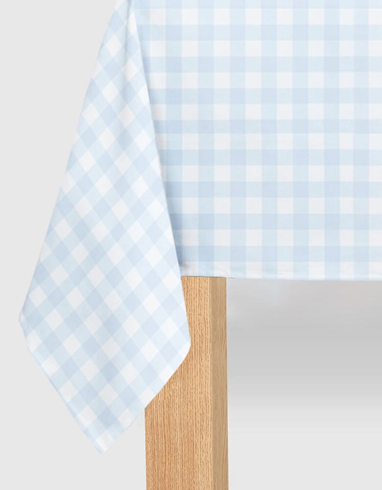 Momo Party's 8.5' x 4.5' Light Blue Gingham Paper Tablecloth by Coterie. Get ready to bring some adorable charm to your summer and spring parties with this Light Blue Gingham Paper Tablecloth! Perfect for a picnic party, this cute tablecloth will add a touch of fun to any occasion. Let the gingham pattern set the tone for a playful and lighthearted gathering.