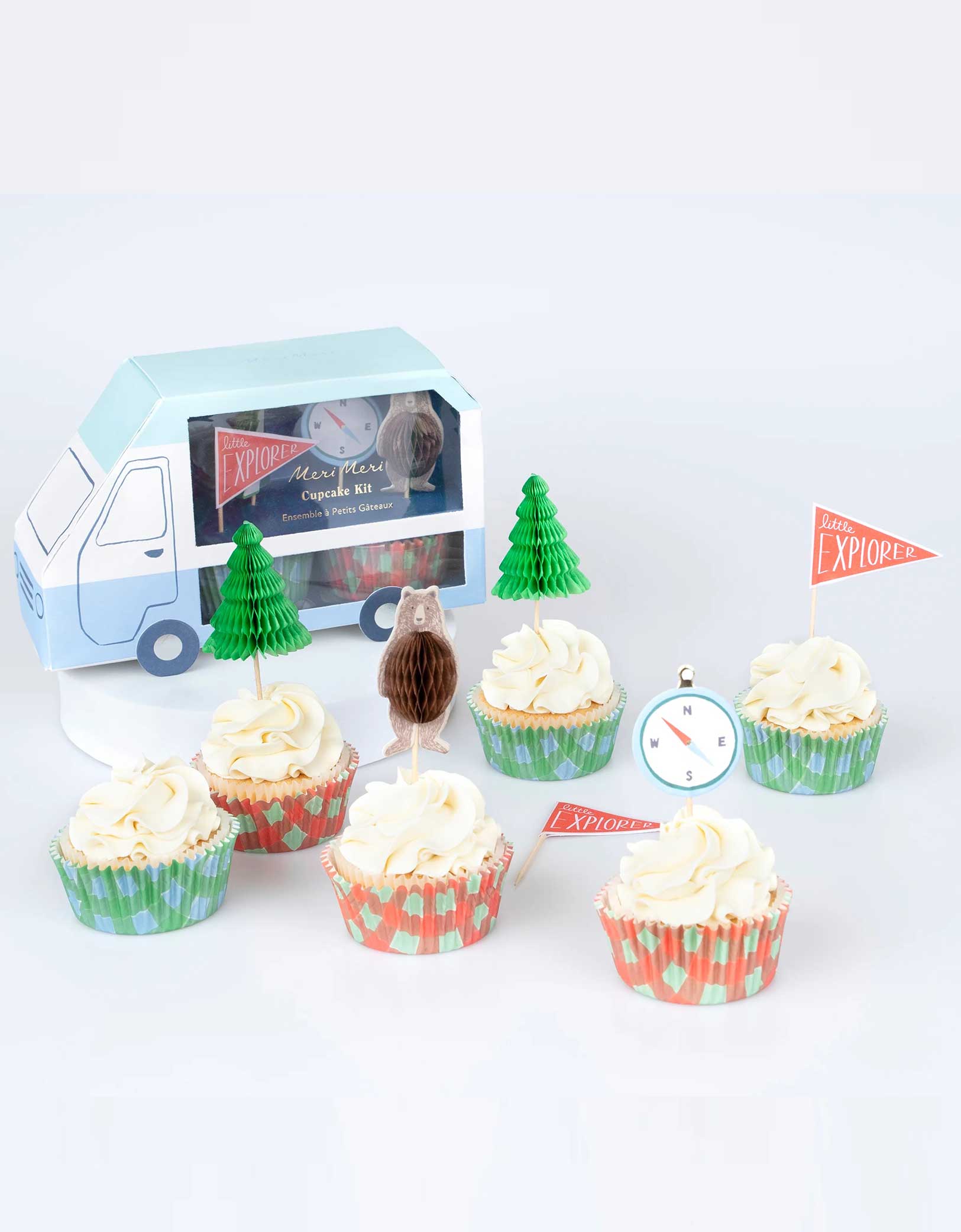 Momo Party's Camping Adventure Cupcake Kit by Meri Meri. This kit includes cake toppers with iconic camping characters and retro designs, teamed with checked cupcake cases. Create a cupcake centerpiece for your camping adventure party, or hand them out to hungry little explorers as a sweet treat. This kit is beautifully presented in a camper van style box. 24 cupcake toppers in 4 designs, including honeycomb bears, honeycomb trees, compasses and explorer flags, with shiny gold foil details.