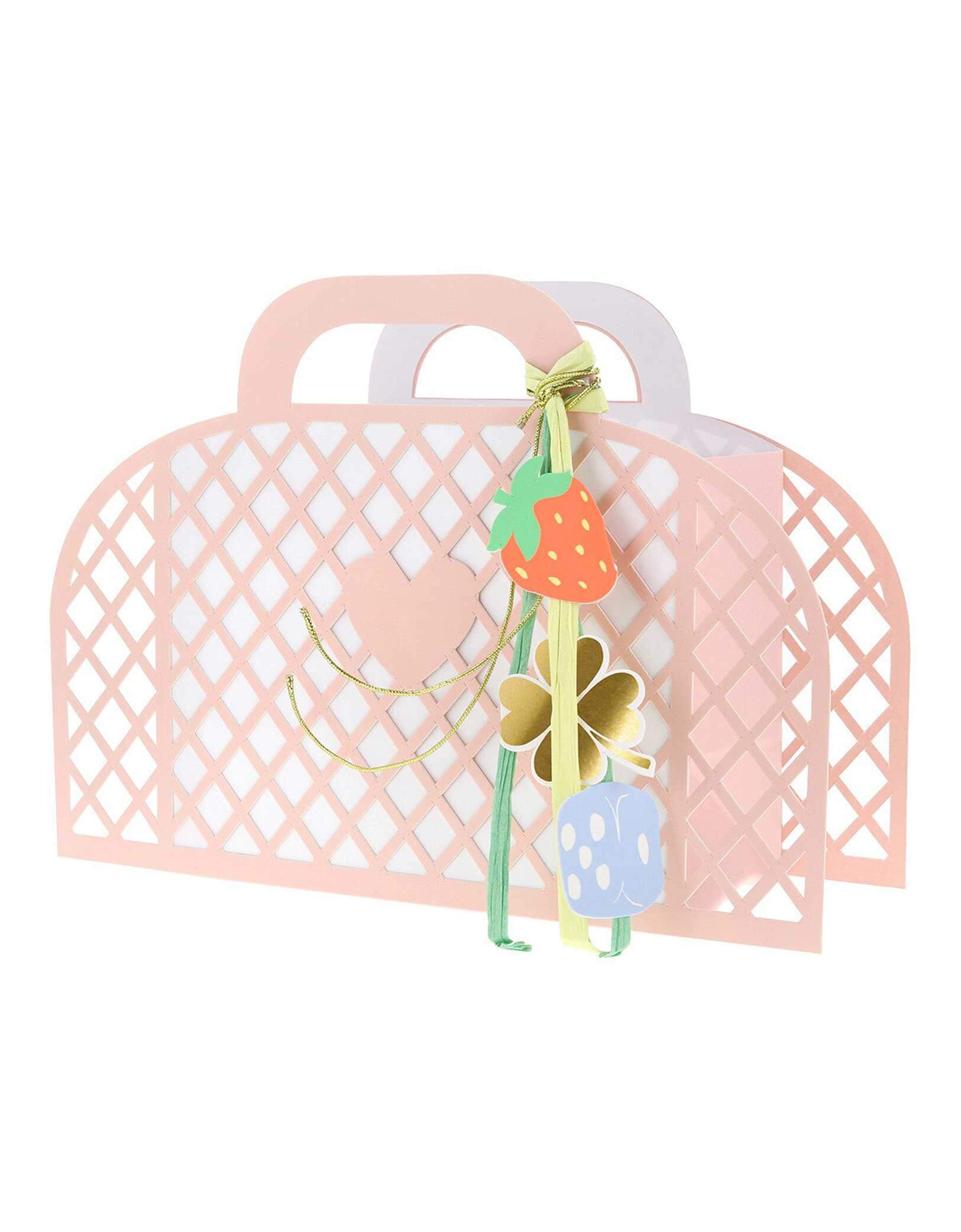 Momo Party's pink paper tote basket with decorative keychain charm elements by Meri Meri on a white background.