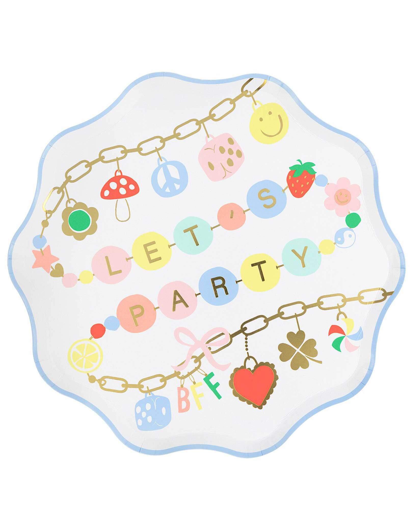 Momo Party's 10.25" dinner plate with wavy pastel blue edge, colorful charms and LET's Party in gold foil by Meri Meri on a white background. A set of plates perfect for girl's sleepover party or a BFF gathering.