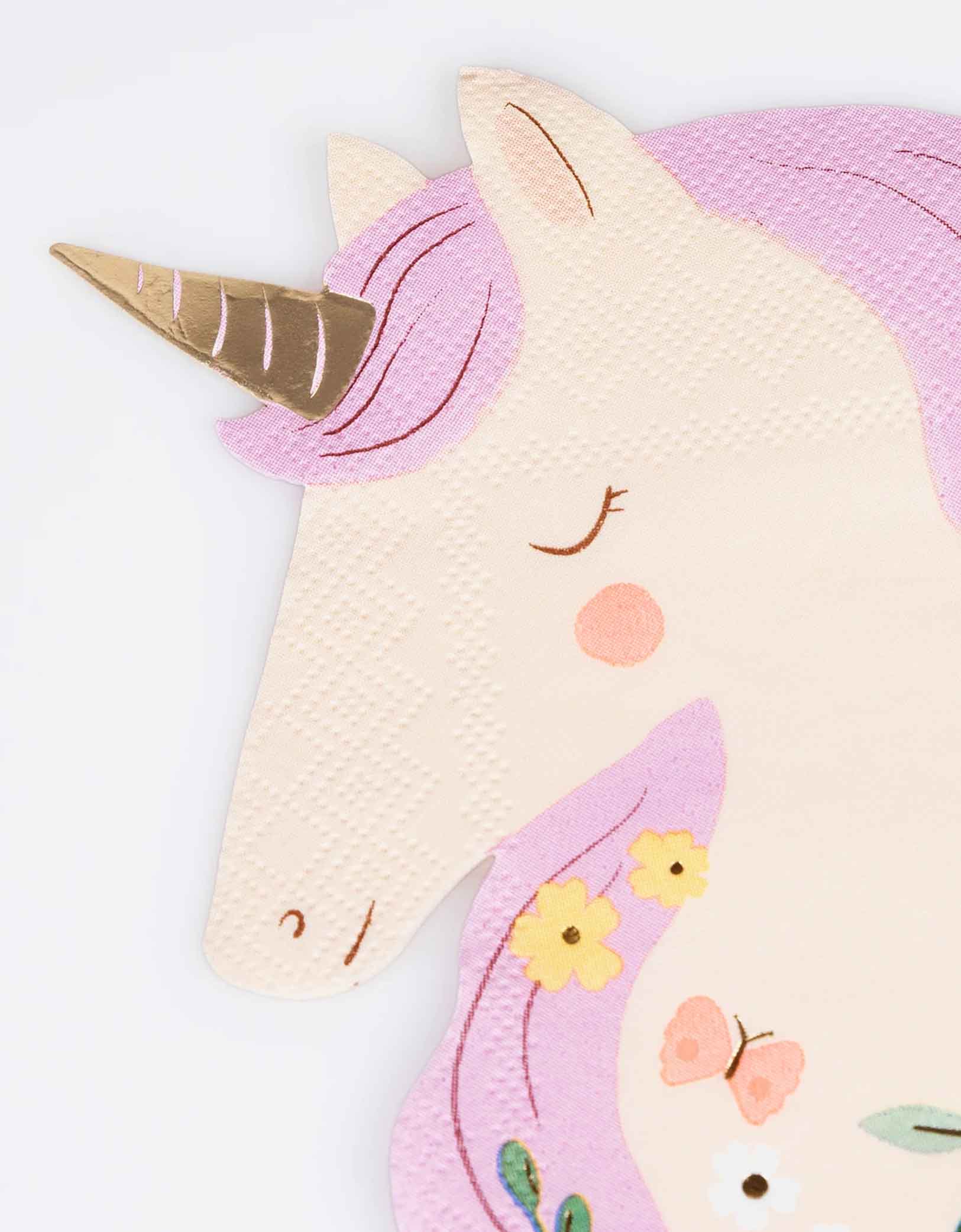 A close up shot on Momo Party's 6.25" x 6.375" Meadow Unicorns Shaped Napkin by Meri Meri. Comes in a set of 16, these pretty paper napkins will instantly make your little girl's unicorn or princess party look so magical. Great for table layering and mixing and matching with pastel tableware and decorations.