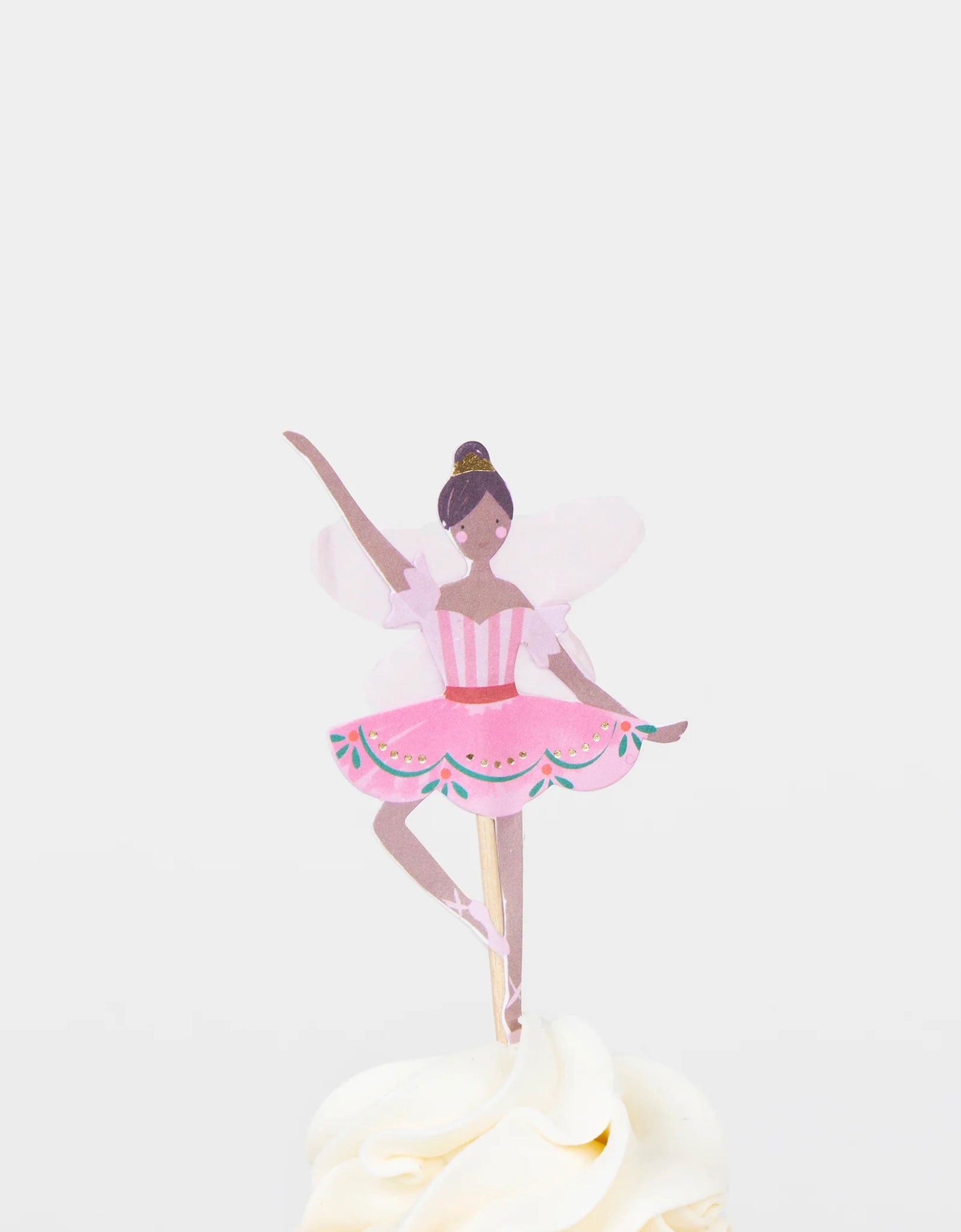 A cupcake decorated with Momo Party's Nutcracker pink ballerina topper.