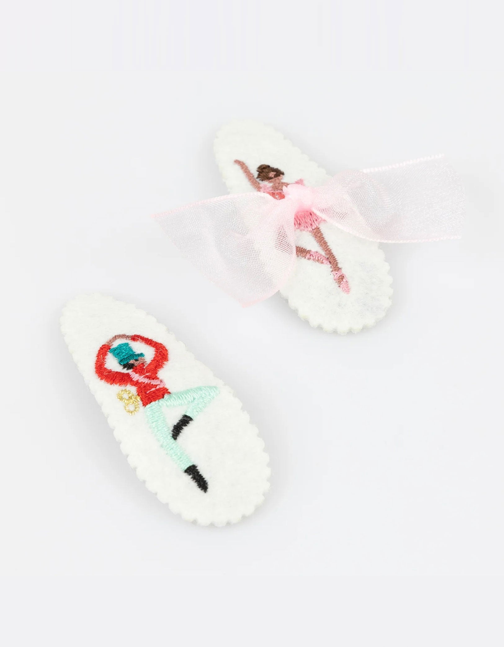 Momo Party's set of Nutcracker hair clips featuring iconic characters including a ballerina and the Nutcracker soldier by Meri Meri on a white background. A gorgeous gift or stocking filler for those who adore statement hair accessories.