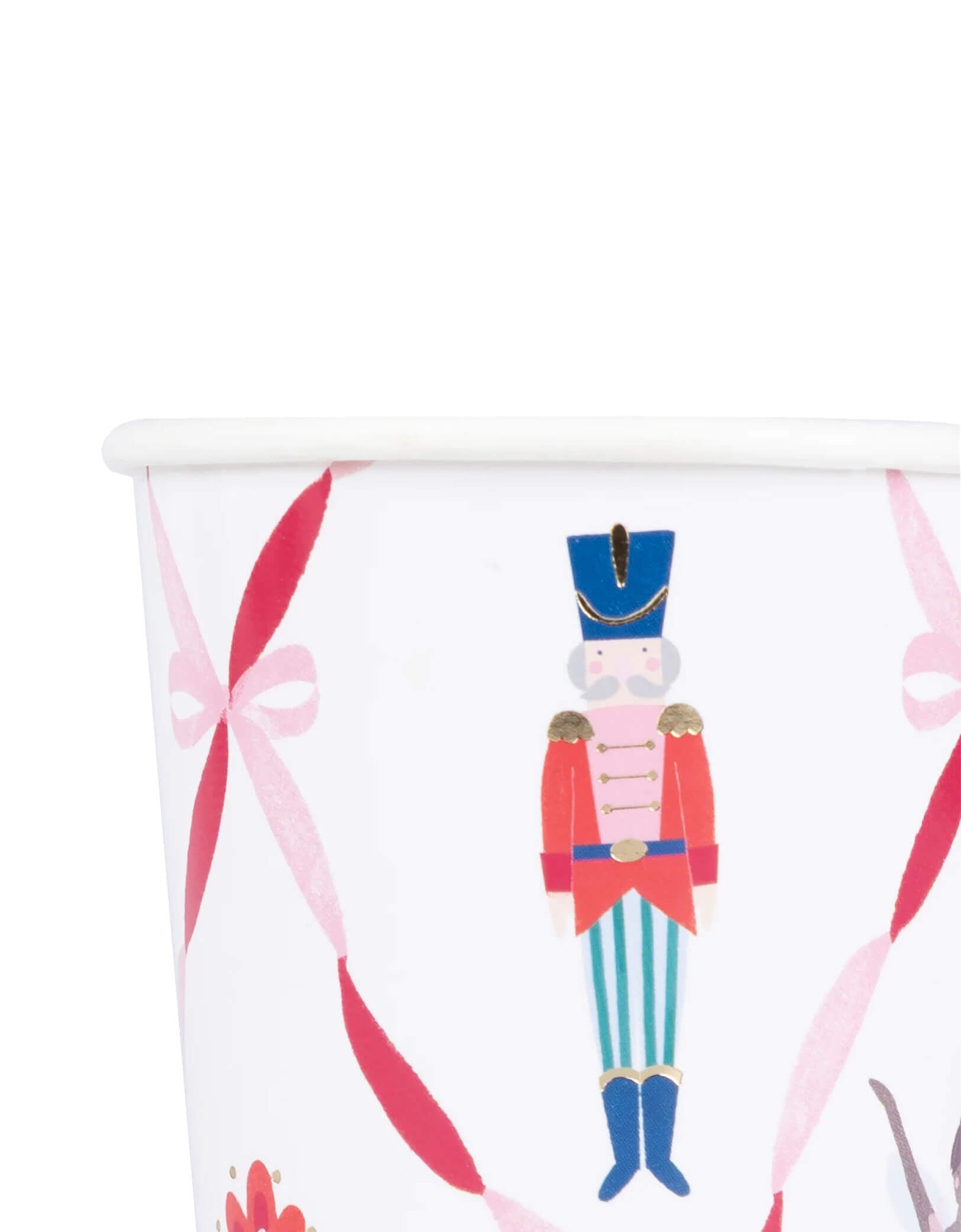 A close-up image of Momo Party's 9oz Nutcracker Ballet Cup by Meri Meri with pink ribbon bows and Nutcracker soldier design on a white background.