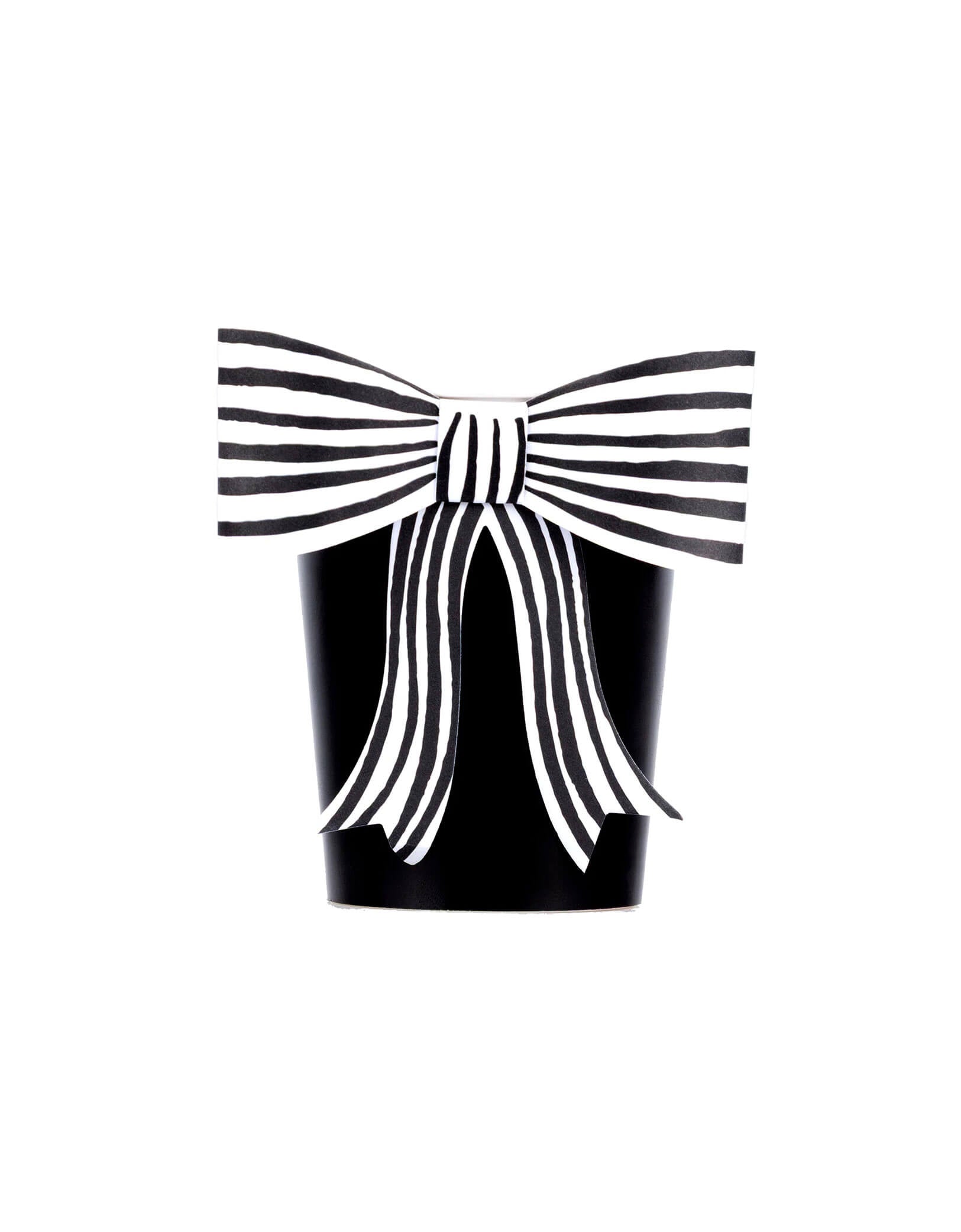 Momo Party's 9 oz Black & White Stripy Bow Party Cup by Meri Meri on a white background. These black cups, adorned with chic striped bows, add a spellbinding touch to your party drinks. The classic black-and-white design pairs beautifully with the rest of your Halloween tableware and decorations.