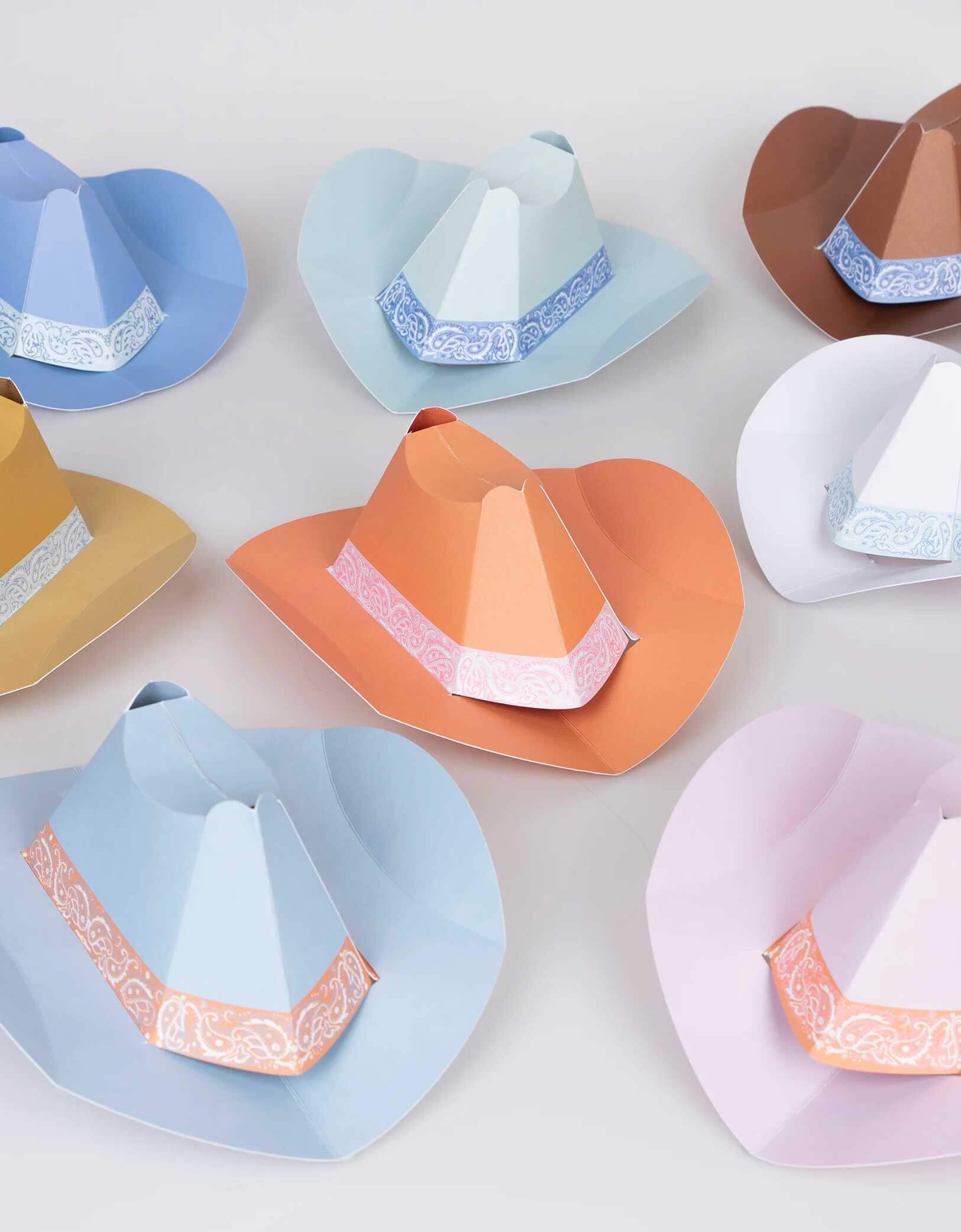 Momo Party's 6.3" Colorful Mini Western Party Hats by Meri Meri. Comes in a set of 8 in 8 different colors, these adorable paper hats in the classic cowboy hat shape bring a touch of the frontier to your Western themed party, be it birthdays, country music gatherings, or barbecues. They're suitable for cowgirls and cowboys of all ages. Add them to the table for instant decoration and watch your guests have a rootin' tootin' good time wearing them.
