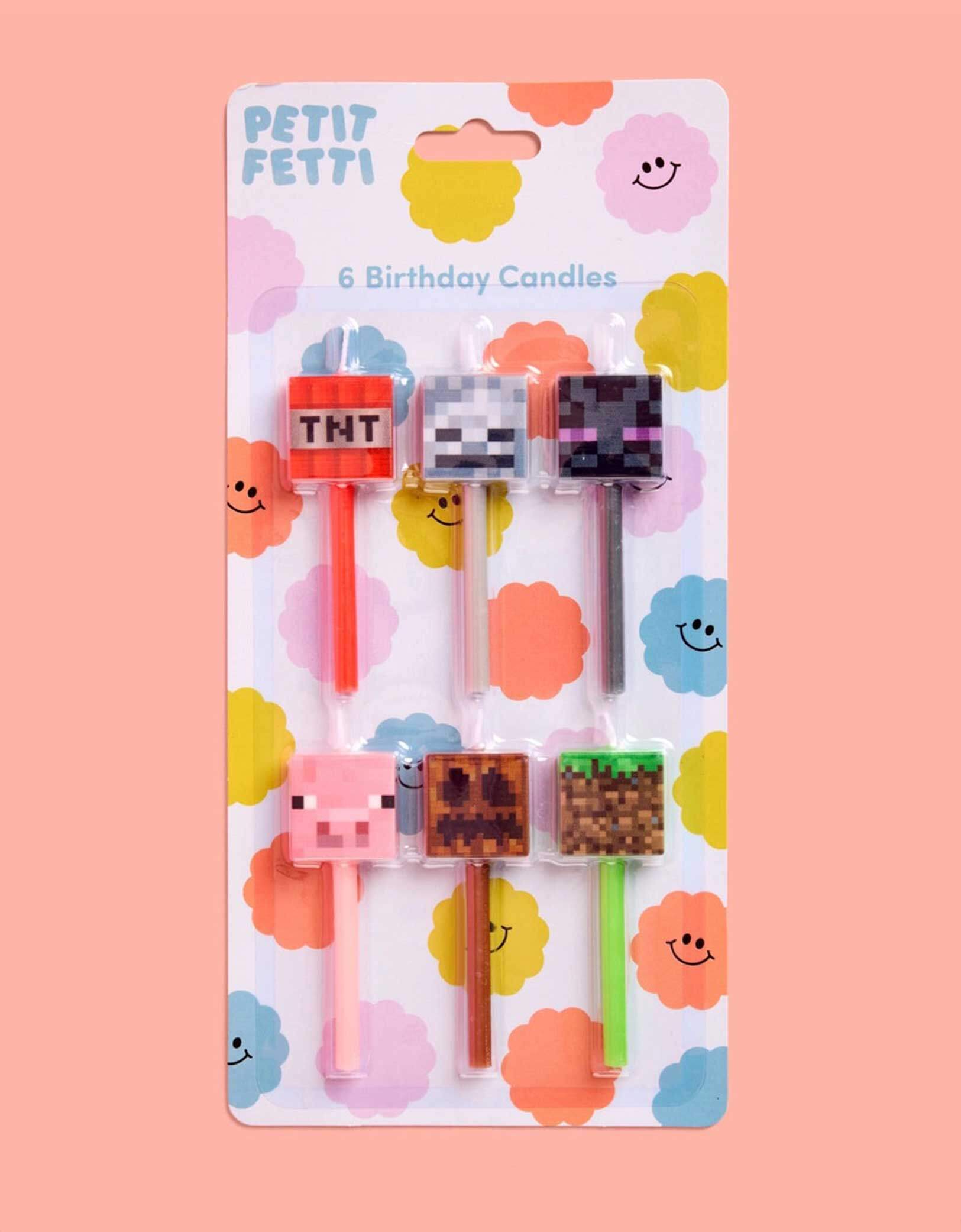 Set of six Momo Party's 3" Minecraft-themed birthday candles featuring TNT, pig face, Enderman and pixel faces in packaging on a pink background.