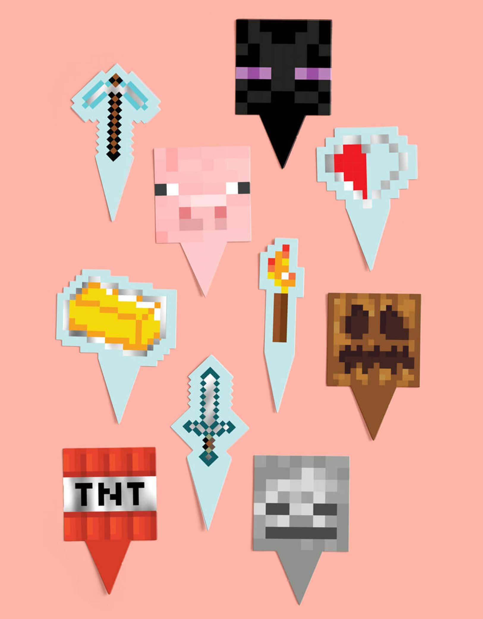Momo Party's set of Minecraft-themed cupcake toppers featuring the TNT, pixel sword, pig face, ghost face, gold brick, Enderman and more on a pink background.