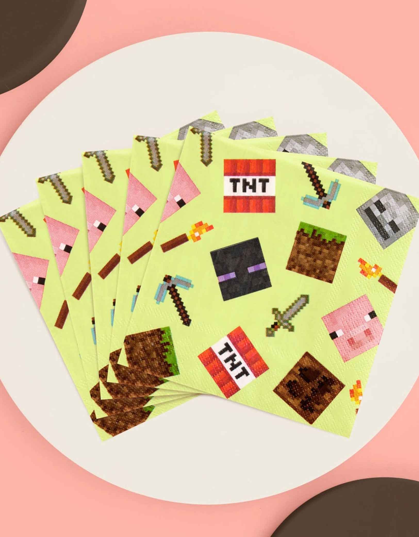 A set of Momo Party's 5" x 5" Minecraft-themed decorative paper napkins with pixelated icons on a pink background.