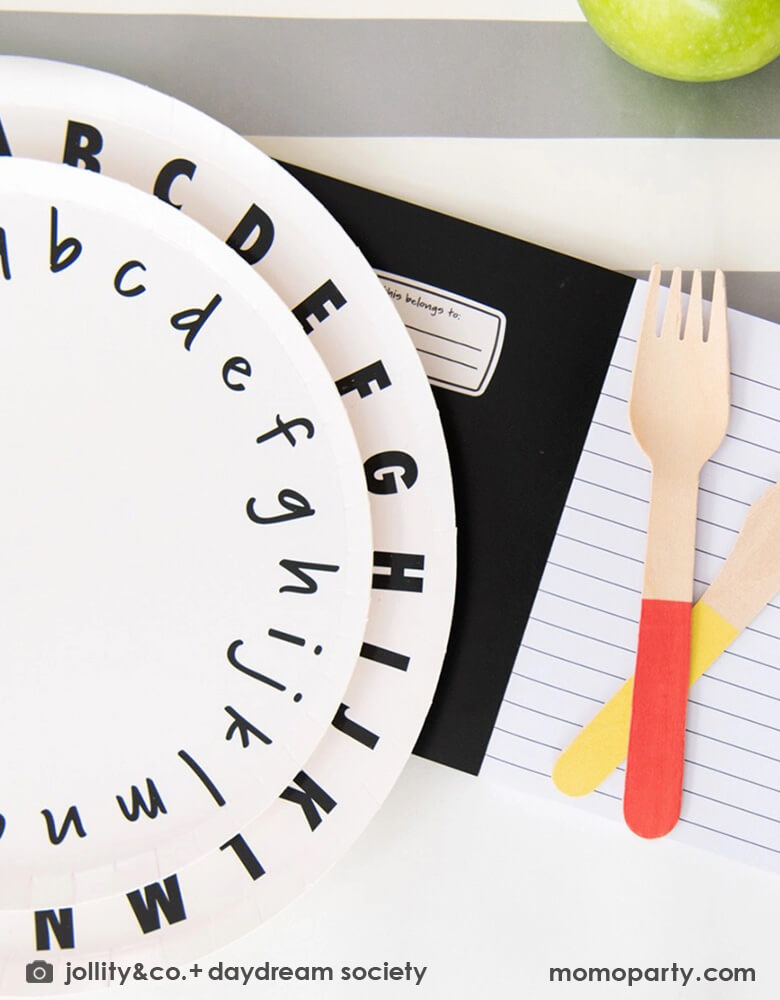 A close up of Momo Party's school days ABC large and small plates by Daydream Society. Along with the notebook invitation and color dipped wooden utensils, this makes a great inspiration for a school themed celebration.