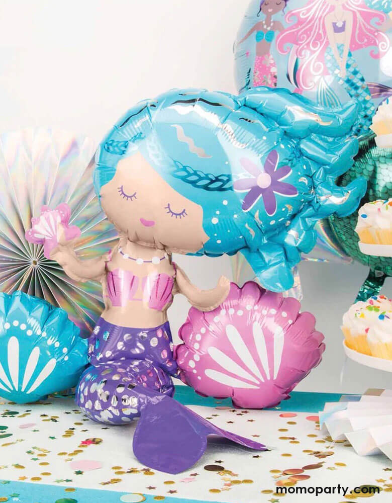Momo Party's 18 inches Air Filled Sitting Mermaid Foil Balloon by Anagram Balloons. Add a whimsical touch to your mermaid party with this beautiful air-filled sitting mermaid foil balloon. This free-standing mermaid shaped foil balloon doesn't require helium and makes a perfect centerpiece for your kid's mermaid birthday party. This balloon includes a self-sealing valve, preventing the gas from escaping after it's inflated.