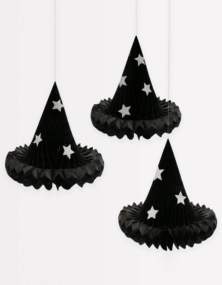 Momo Party's 13.25" x 12.875" Witch Hat Hanging Decorations by Meri Meri. Whether they are hanging in your home, or gently swaying in your porch or garden, these versatile witch hats will delight all visitors on Halloween. They come with silver metallic cord for hanging – why not try tying them at different lengths for maximum effect? The glitter stars will shine brightly to mesmerize your guests too.