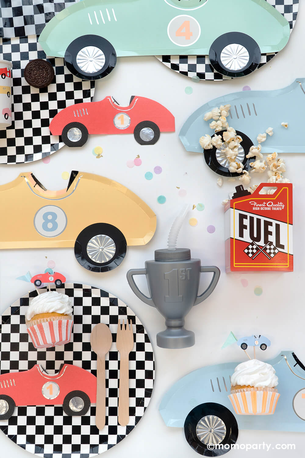 Momo Party's Race Car Party Collection featuring Meri Meri's vintage race car paper plates in 8 different colors, red race car shaped napkins, round checkered dinner plates, race car cupcake kit and toppers, fuel treat box with popcorn and trophy shaped tumbler sipper - perfect for kid's "Two Fast" race car themed second birthday party or "Fast One" first birthday party.