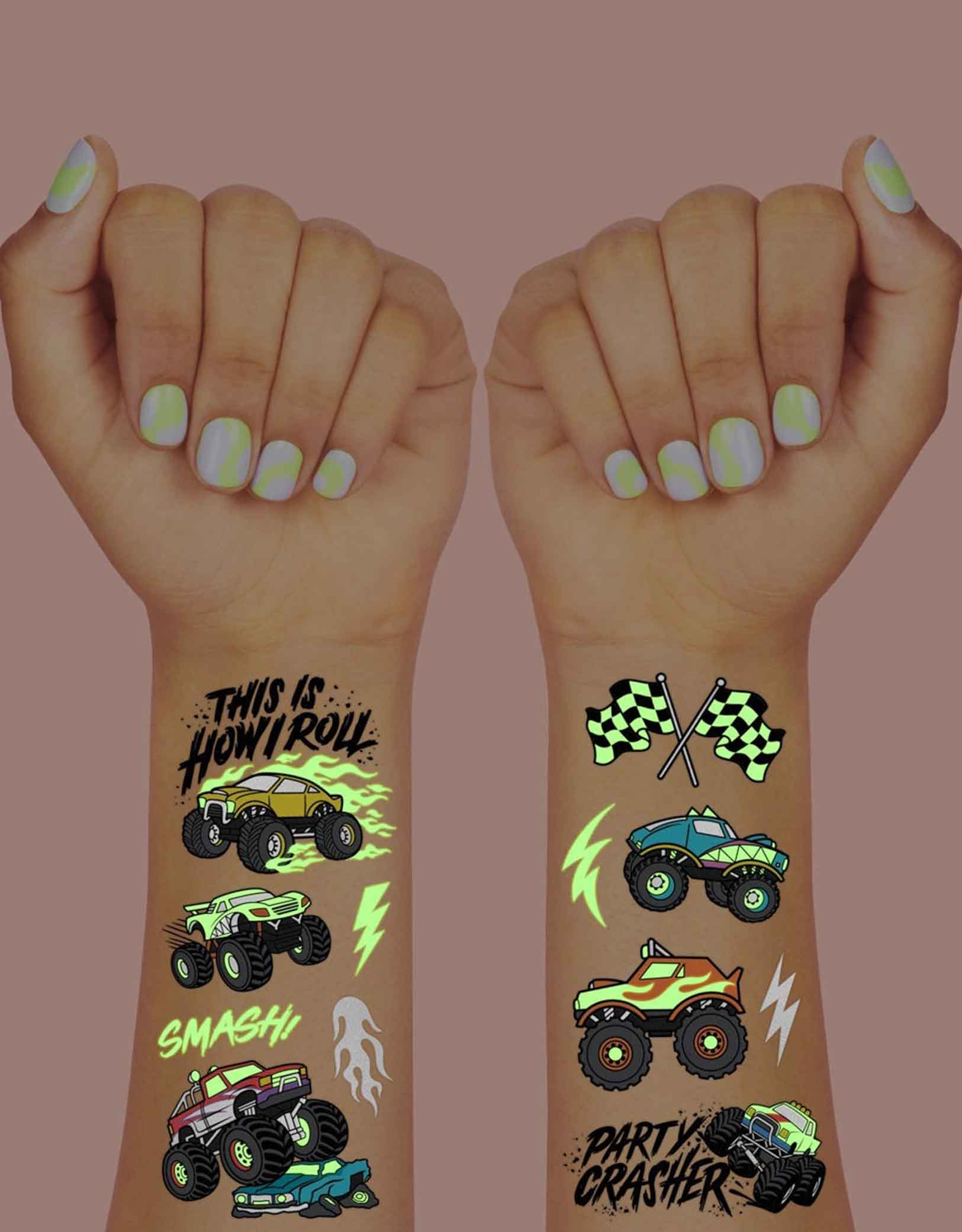 Two arms decorated with Momo Party's 8.25" x 6" Monster Truck Glow in the Dark Kids Temporary Tattoos by xo, fetti. Comes in a set of 50 tattoos, these awesome glow-in-the-dark Monster Truck temporary tattoos are guaranteed to be a wheel good time at your kid's Monster Truck birthday party! 50 designs means nobody gets left behind - invite all of your bffs to crash this party because these tats are sure to be fire!