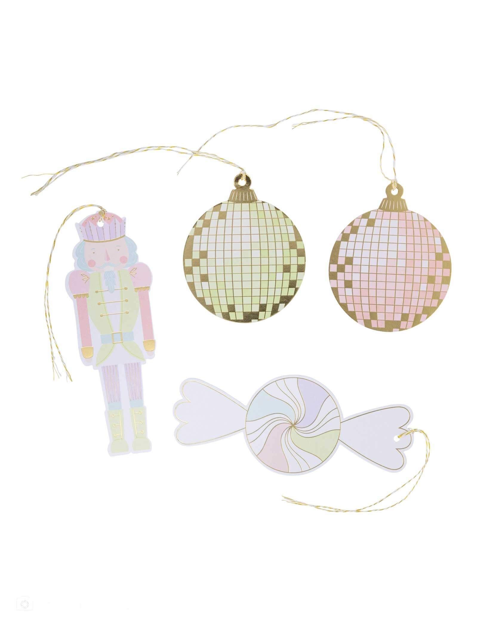 Momo Party's set of pastel colored Christmas themed gift tags including a Nutcracker, disco balls, and a candy with gold strings by My Mind's Eye on a white background.