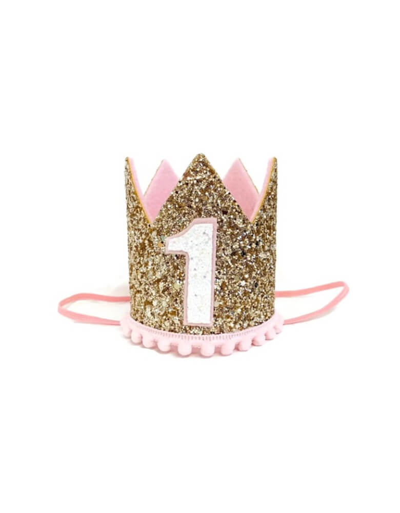 Momo Party's 3" pink and gold glittered first birthday party hat by Little Blue Olive. This adorable birthday crow with gold & pale pink is perfect for your one year old baby girl! It's great for your little girl's first birthday party or a milestone photoshoot! This crown is hand-made of sturdy fabric, and is attached to a skinny elastic headband which is designed to be worn around the back of the head - like a headband.