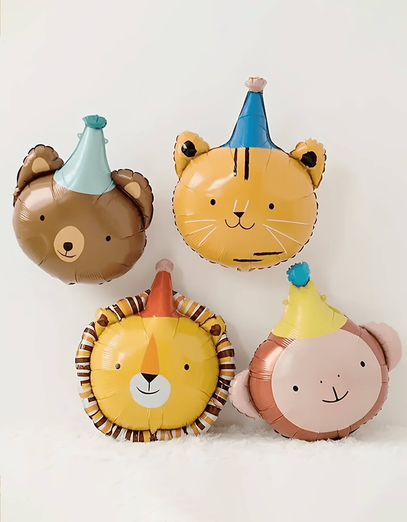 Momo Party's Animal Parade Animal Foil Balloon Set featuring a bear, a lion, a tiger and a monkey in their party hat. Accent your carnival or animal themed party with these adorable party hat shaped foil mylar balloons. These balloons include a self-sealing valve, preventing the gas from escaping after it's inflated. The balloon can be inflated with helium to float or with a balloon air inflator.