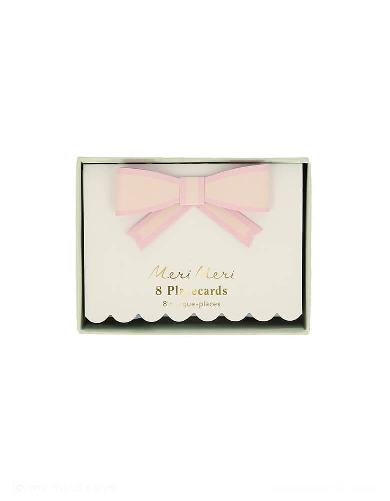 A close up of Momo Party's 3.5"x 2.5" Pastel Bow Place Cards by Meri Meri in its packaging. Featuring pretty pastel colors in 8 different colors, including pale pink, pink, dark pink, ivory, yellow, peach, mint and blue, each of the place card has a 3D paper bow on them, making this an elegant yet darling addition to your tableset.