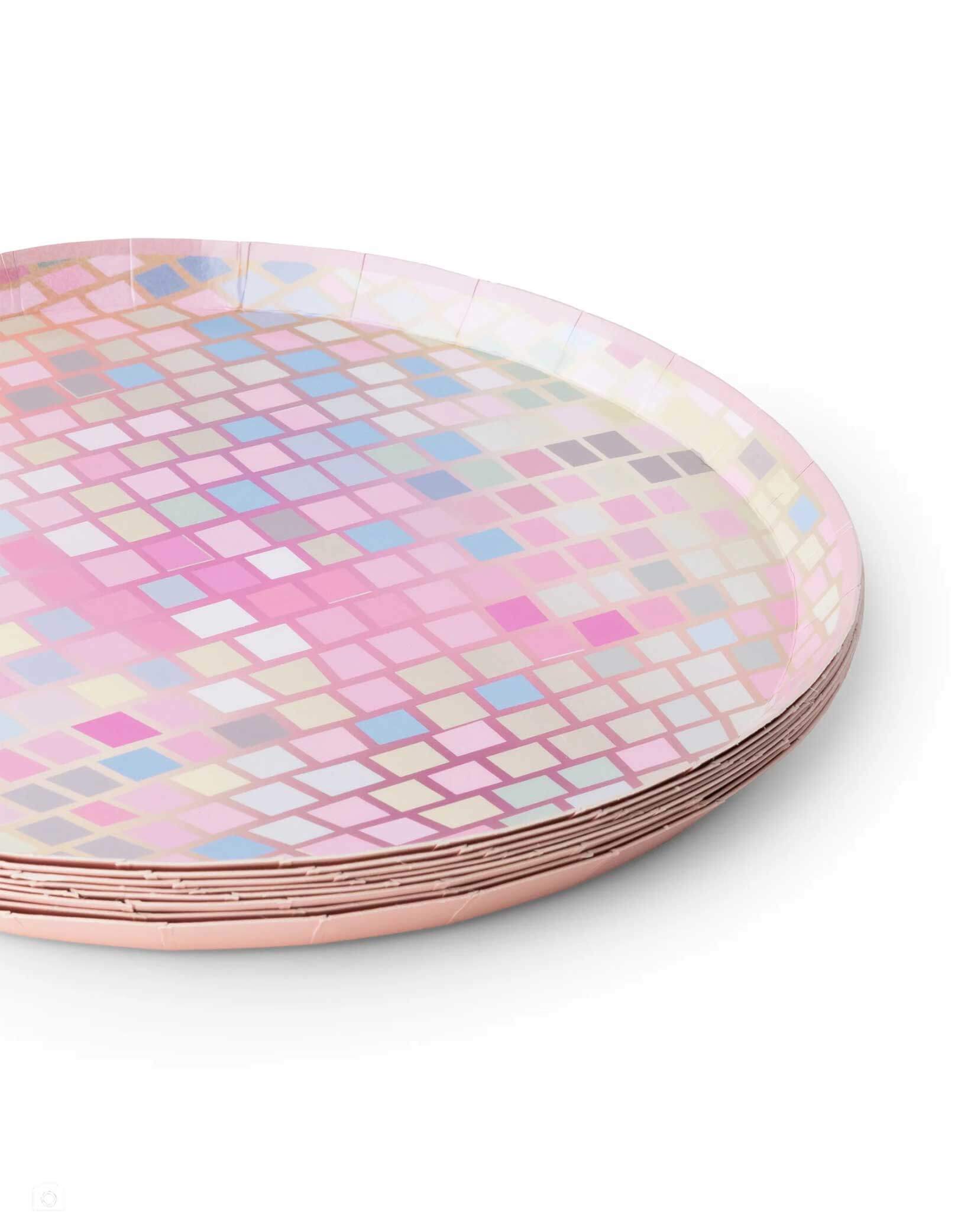 A stack of Momo Party's 8" Pink Disco Ball Plates by Bonjour Fete on a white background. Covered with dazzling pink foil, these plates are perfect for creating a shimmering atmosphere. Whether it's a Disco birthday, a Taylor Swift-themed party, or a fun bachelorette weekend, these plates will add a festive flair that’s ready for the dance floor.