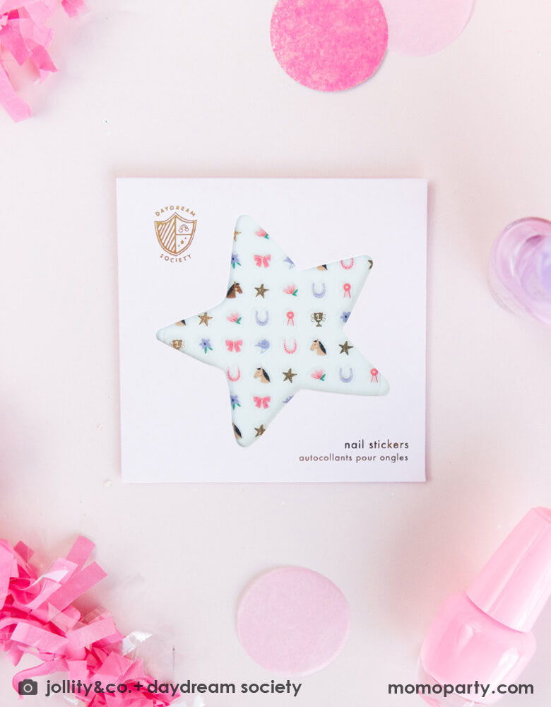 Momo Party's pony tail cowgirl nail stickers by Daydream Society on a pale pink party table with pink confetti, streamers and nail polish bottle around them. Comes in a sheet of 100 nail stickers, with designs of horses, show ribbons, florals and more, these stickers make perfect addition to your little girl's pony, cowgirl or rodeo themed birthday party activities!