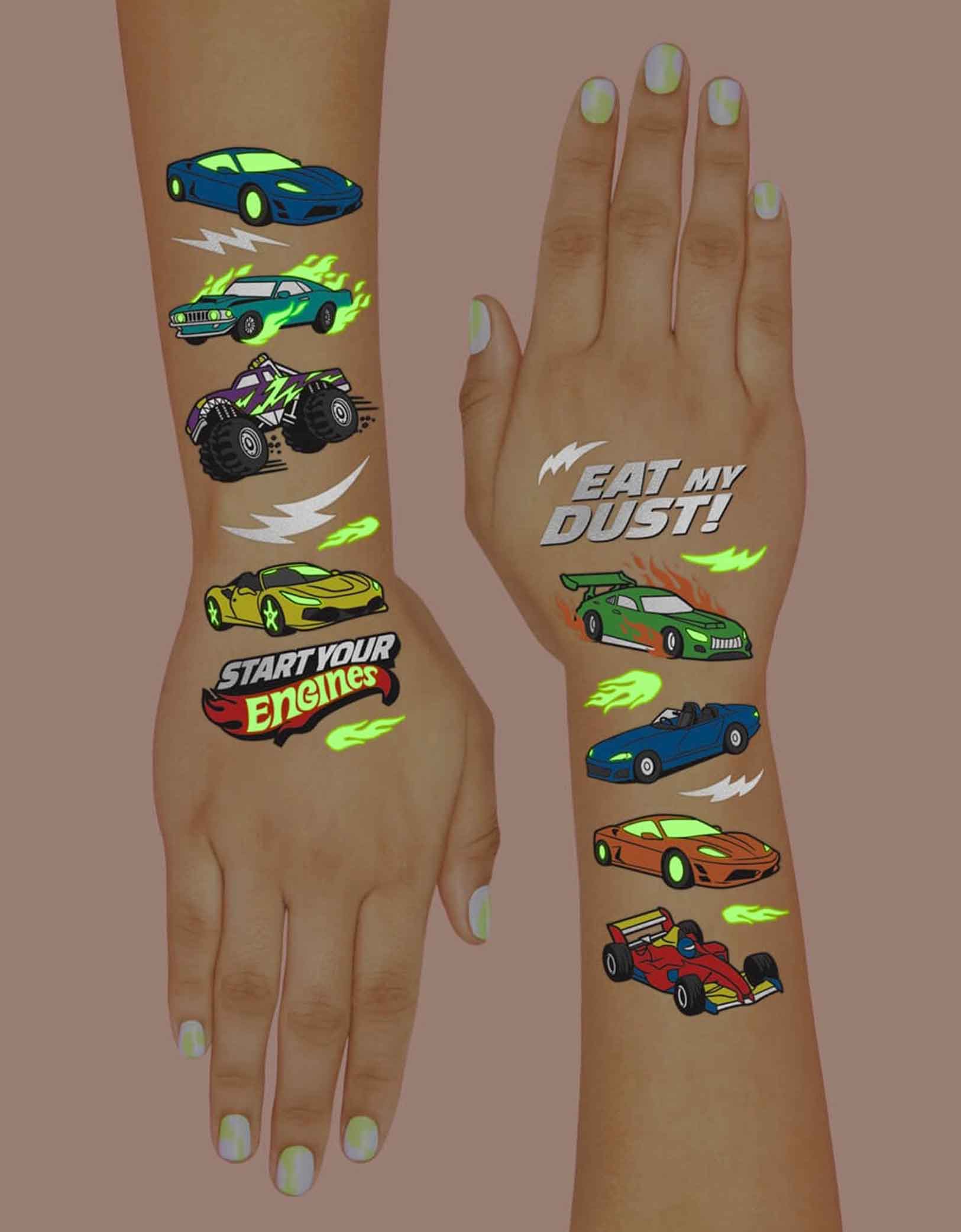 Two hands with colorful race car themed temporary tattoos from Momo Party with text "Eat my dust" & "Start Your Engines" glow in the dark on a dark background.