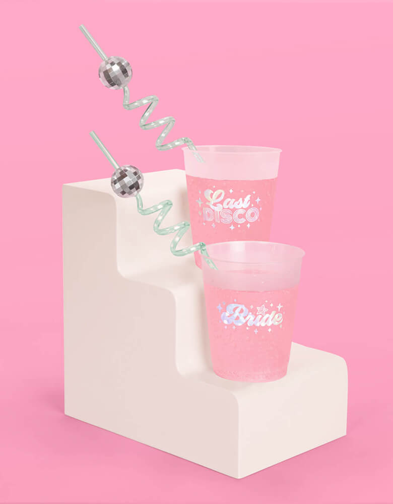 Momo Party's 10" Reusable Disco Party Swirly Straws by Xo, fetti in two disposable cups with Let's Disco and Bride on them.