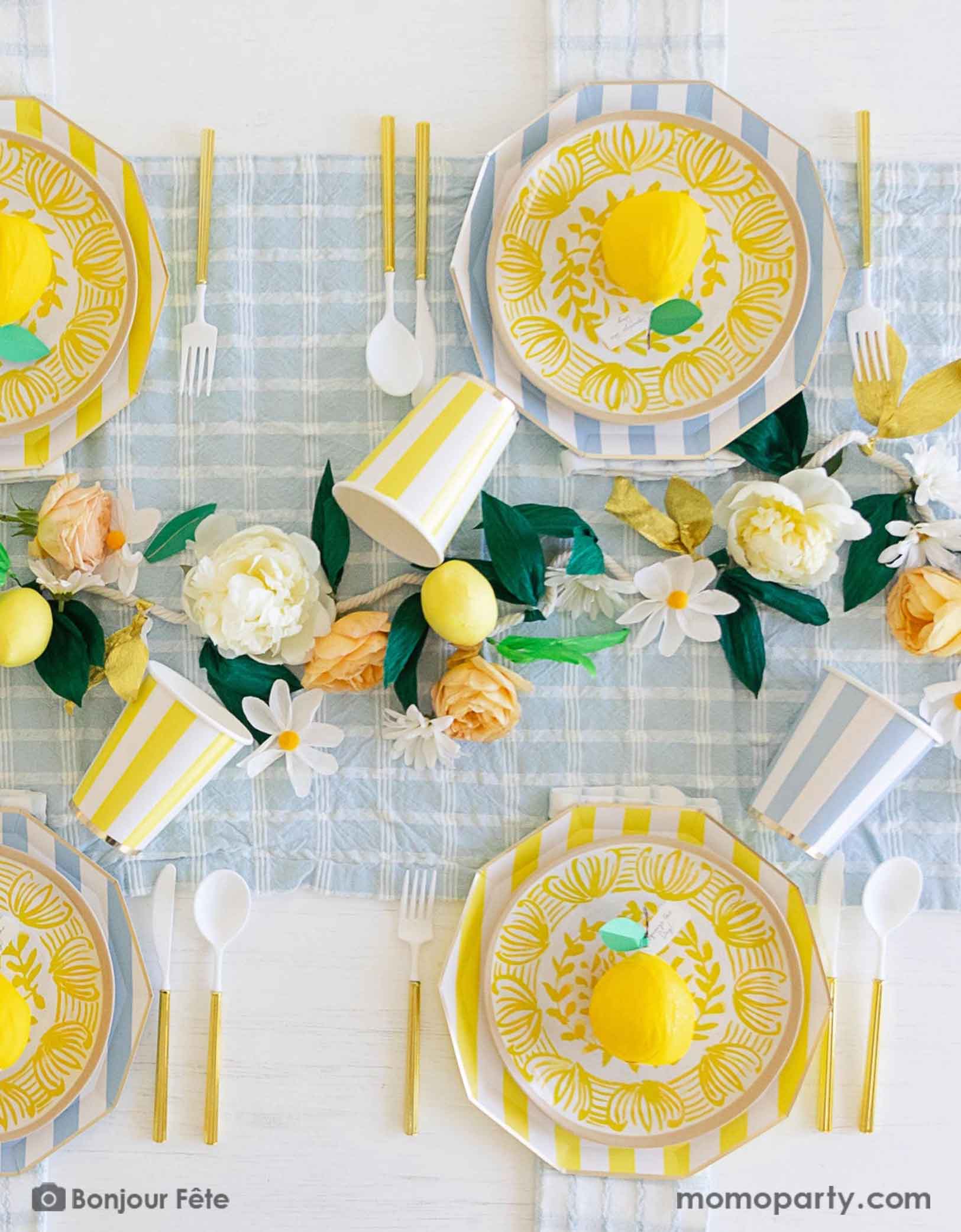 A stunning tableset in a Summer Party Capri Inspired party by Momo Party! Bursting with colors and textures, this stylish setting combines the vibrant striped aesthetics in yellow and sky blue of Capri with the refreshing citrus vibes of lemons and gingham checker patterns. Your guests will be transported to a picturesque seaside Italian village as they enjoy their summer feast underneath these enchanting decorations.