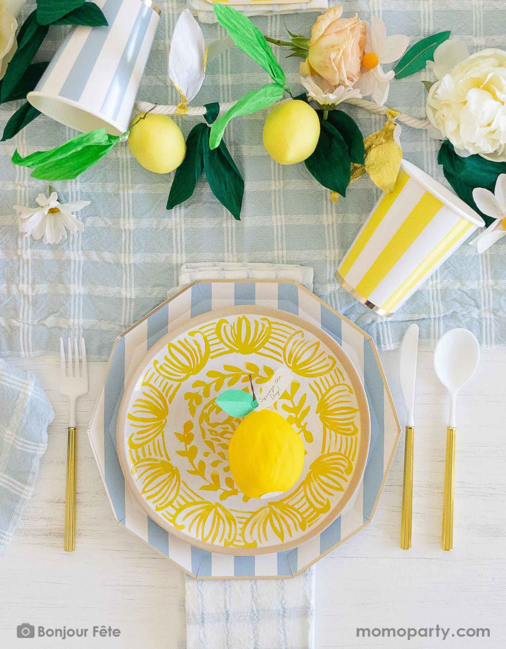 A stunning tableset in a Summer Party Capri Inspired party by Momo Party! Bursting with colors and textures, this stylish setting combines the vibrant striped aesthetics in yellow and sky blue of Capri with the refreshing citrus vibes of lemons and gingham checker patterns. Your guests will be transported to a picturesque seaside Italian village as they enjoy their summer feast underneath these enchanting decorations. Check out momoparty.com for more themed party supplies and decorating ideas!