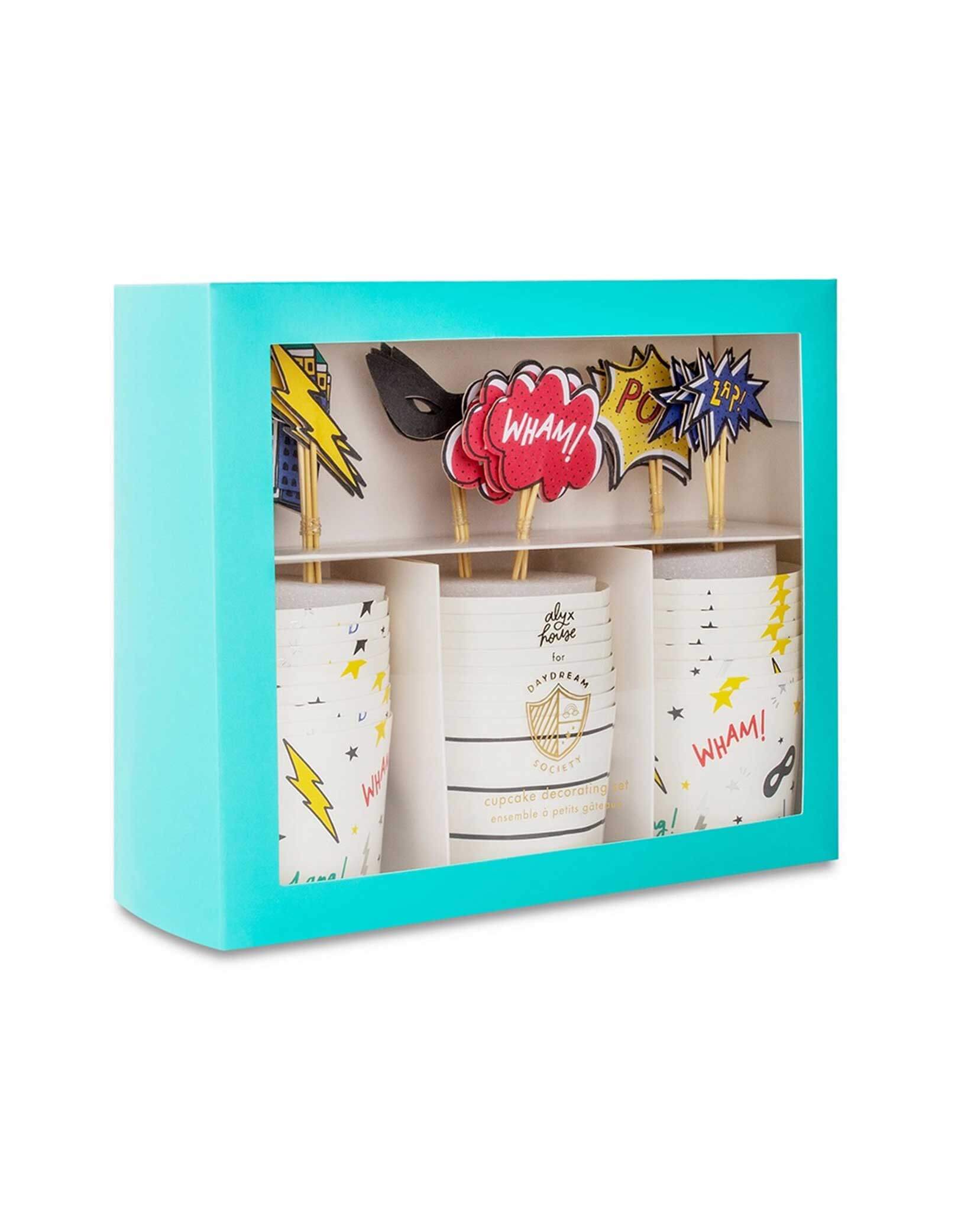 Momo Party's set of superhero cupcake decorating kit with colorful toppers and wraps in a blue box on a white background.
