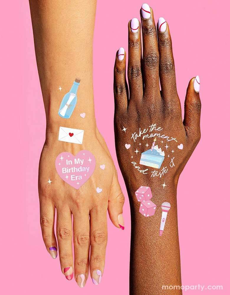 Two hands with Momo Party Birthday Taylor Swift Era Temporary Tattoos by Xo, Fetti. Featuring Taylor Swift inspired designs including the iconic Taylor Swift-themed designs including snakes, butterflies, red lipsticks and more. They're perfect for girl's Taylor Swift themed birthday party activities.