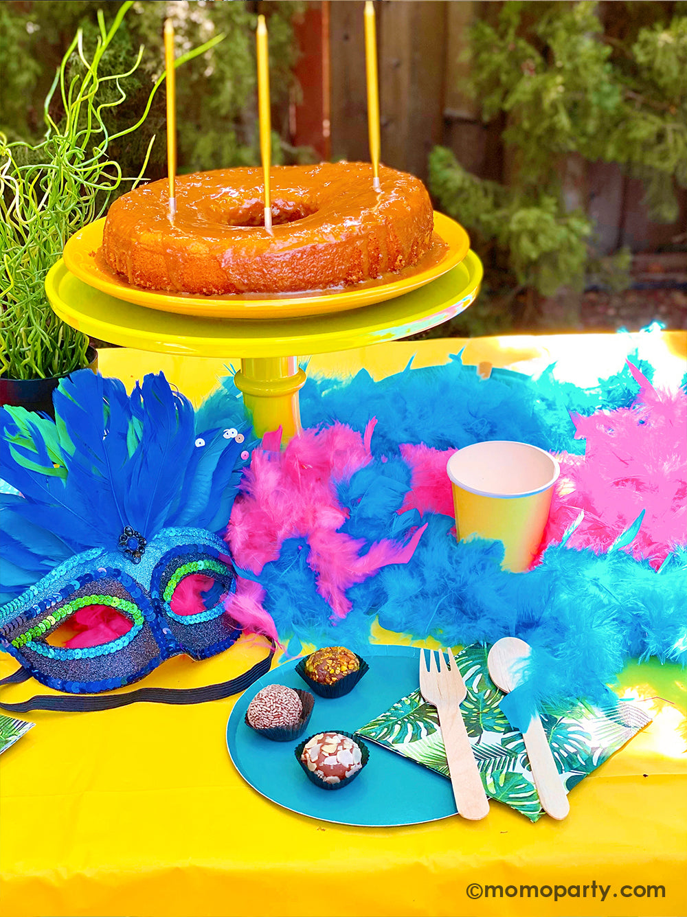 Get ready to throw the ultimate summer celebration with a vibrant Brazilian Carnival-themed party table! Featuring tropical party supplies from Momo Party, this festive setup includes palm leaf napkins, matching plates, and colorful party cups that bring the rainforest vibe to life. Complete the look with feather garlands, carnival masks, decadent chocolate desserts, and a stunning birthday cake. Whether it's for a birthday, summer bash, or themed event, this tropical party setup is perfect for summer!