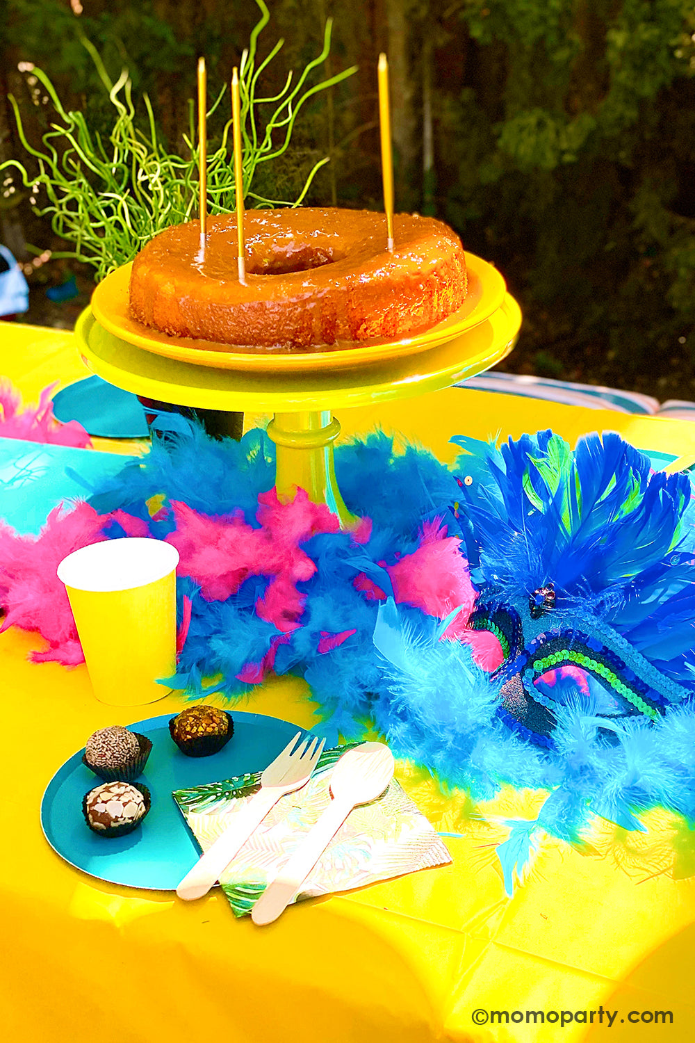 Get ready to throw the ultimate summer celebration with a vibrant Brazilian Carnival-themed party table! Featuring tropical party supplies from Momo Party, this festive setup includes palm leaf napkins, matching plates, and colorful party cups that bring the rainforest vibe to life. Complete the look with feather garlands, carnival masks, decadent chocolate desserts, and a stunning birthday cake. Whether it's for a birthday, summer bash, or themed event, this tropical party setup is perfect for summer!